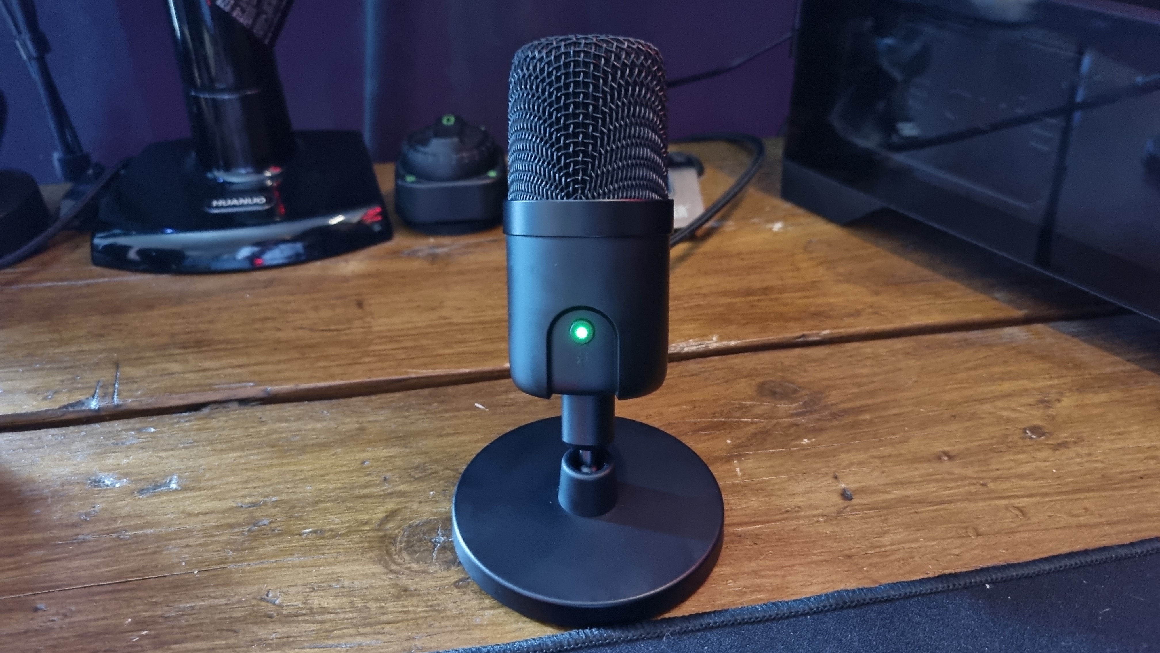 The Amazon Basics USB condenser microphone on a desk