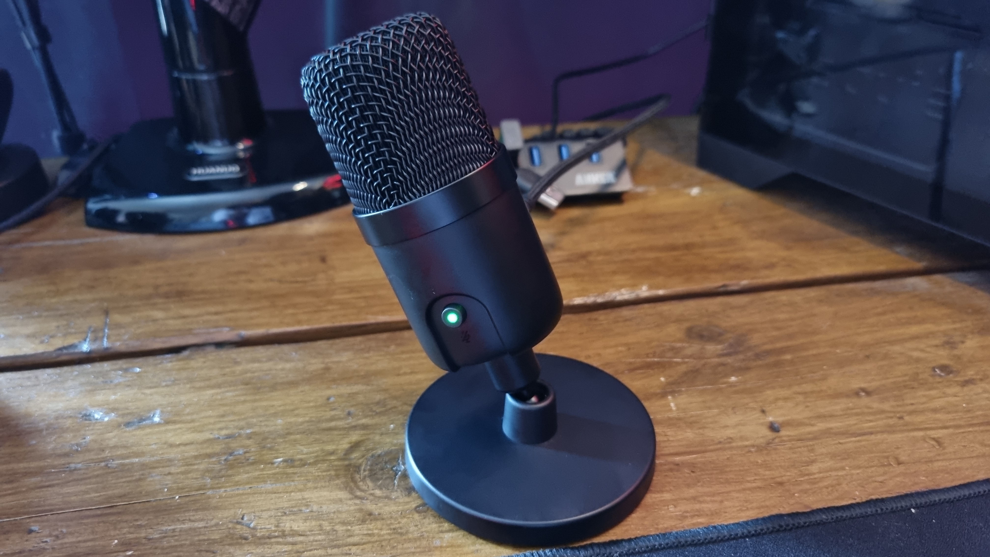 The Amazon Basics USB condenser microphone on a desk, at a jaunty angle