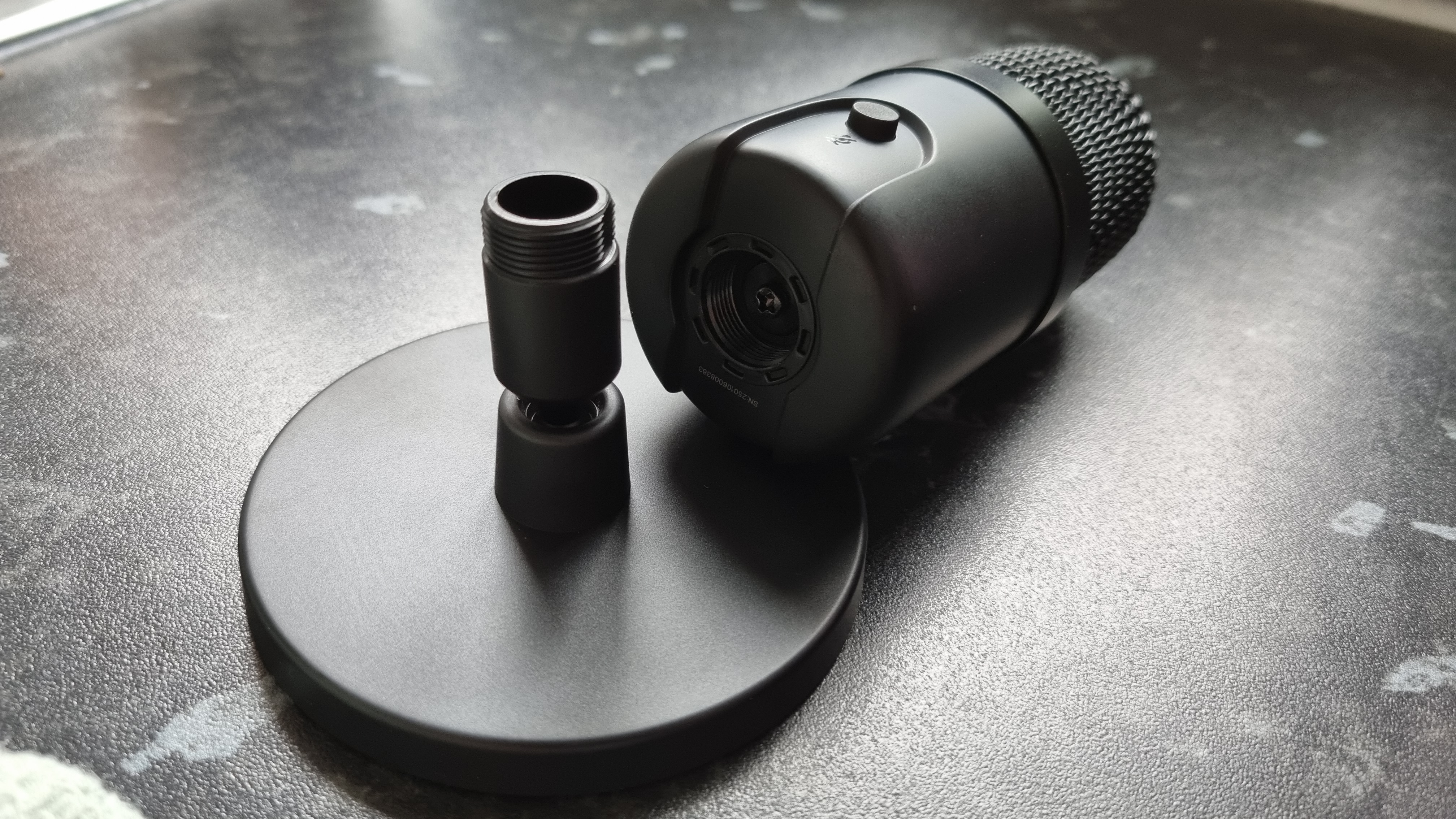 The Amazon Basics USB condenser microphone disassembled from its stand, showing the boom arm socket beneath