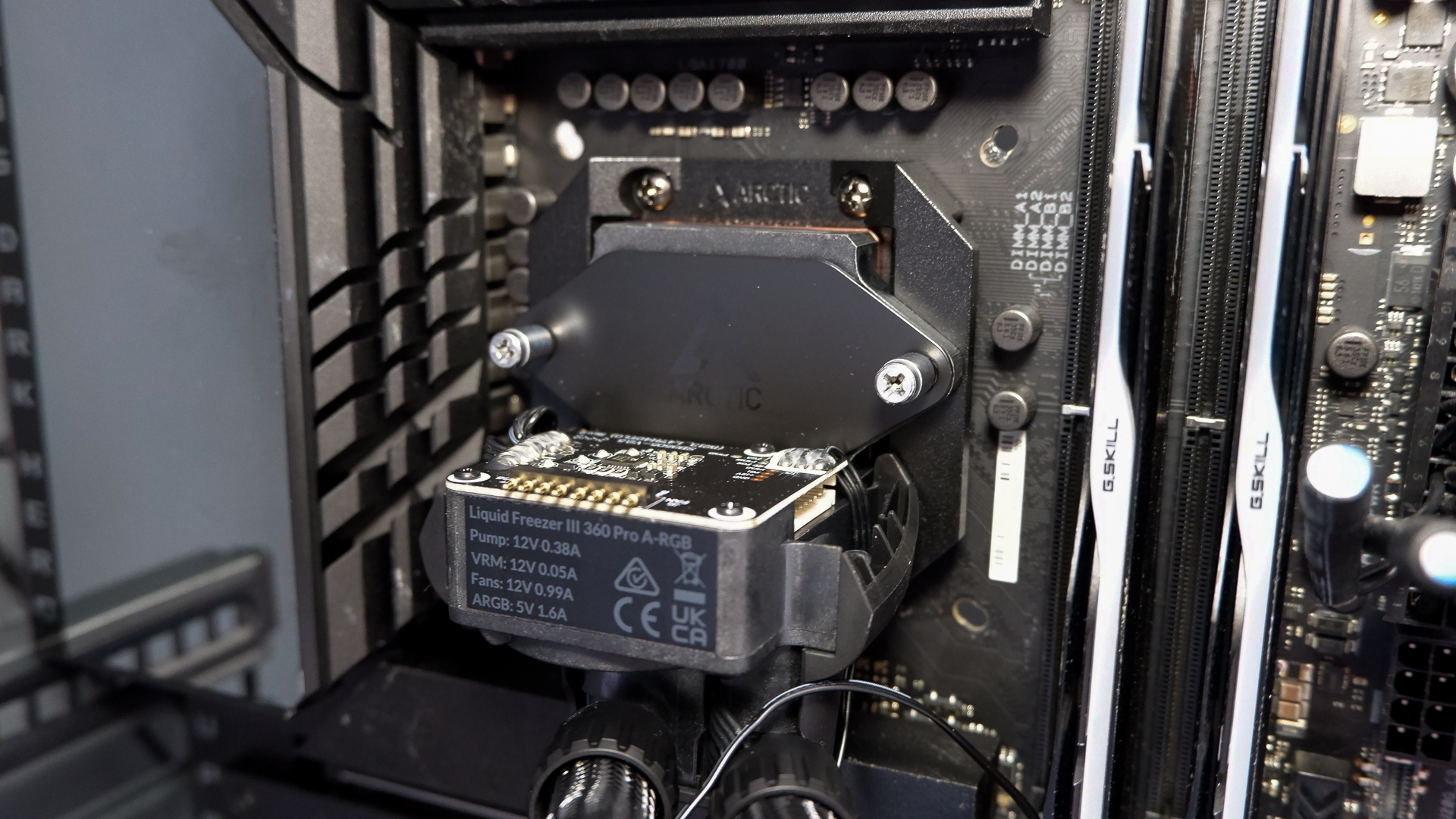 An Arctic Liquid Freezer III Pro liquid cooler set-up on a test bench with the RGB enabled.