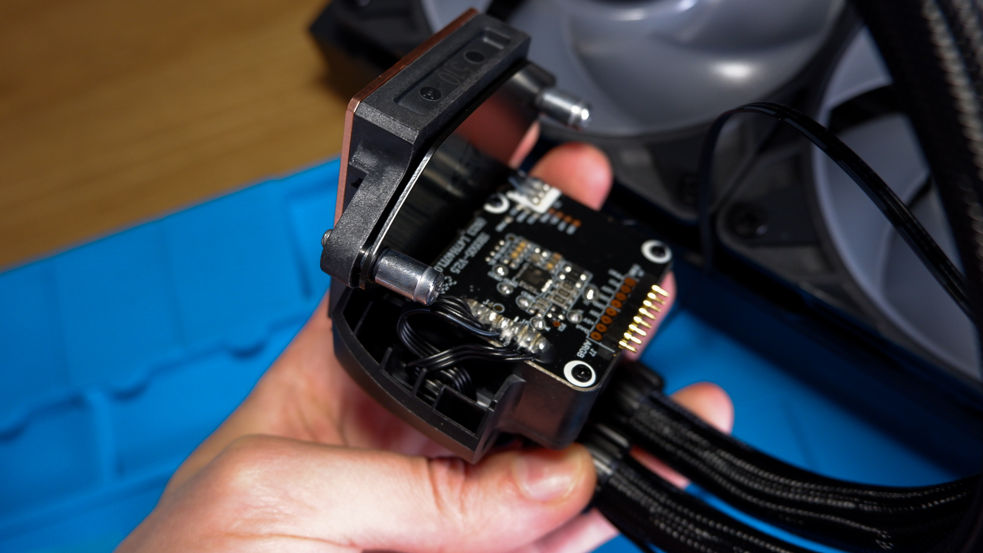 An Arctic Liquid Freezer III Pro liquid cooler set-up on a test bench with the RGB enabled.