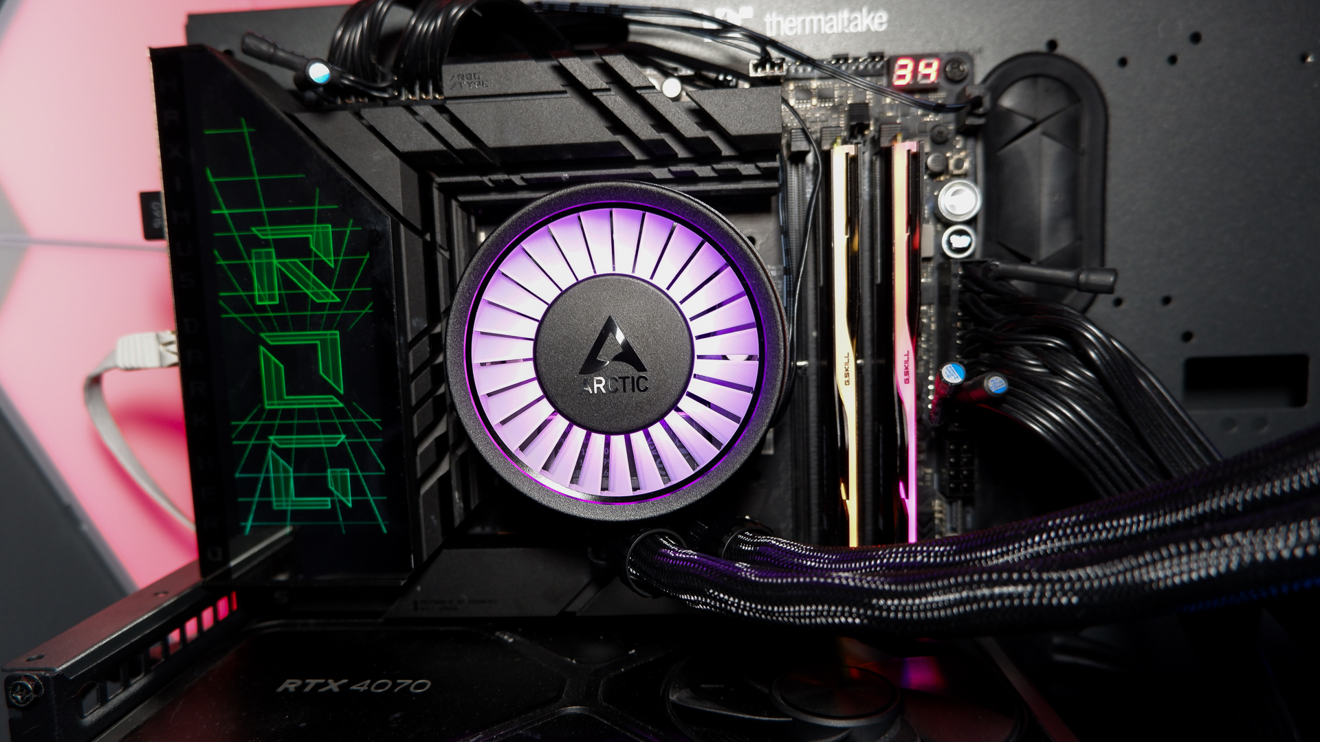 An Arctic Liquid Freezer III Pro liquid cooler set-up on a test bench with the RGB enabled.