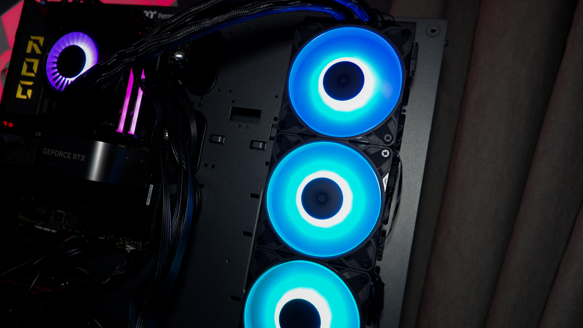An Arctic Liquid Freezer III Pro liquid cooler set-up on a test bench with the RGB enabled.