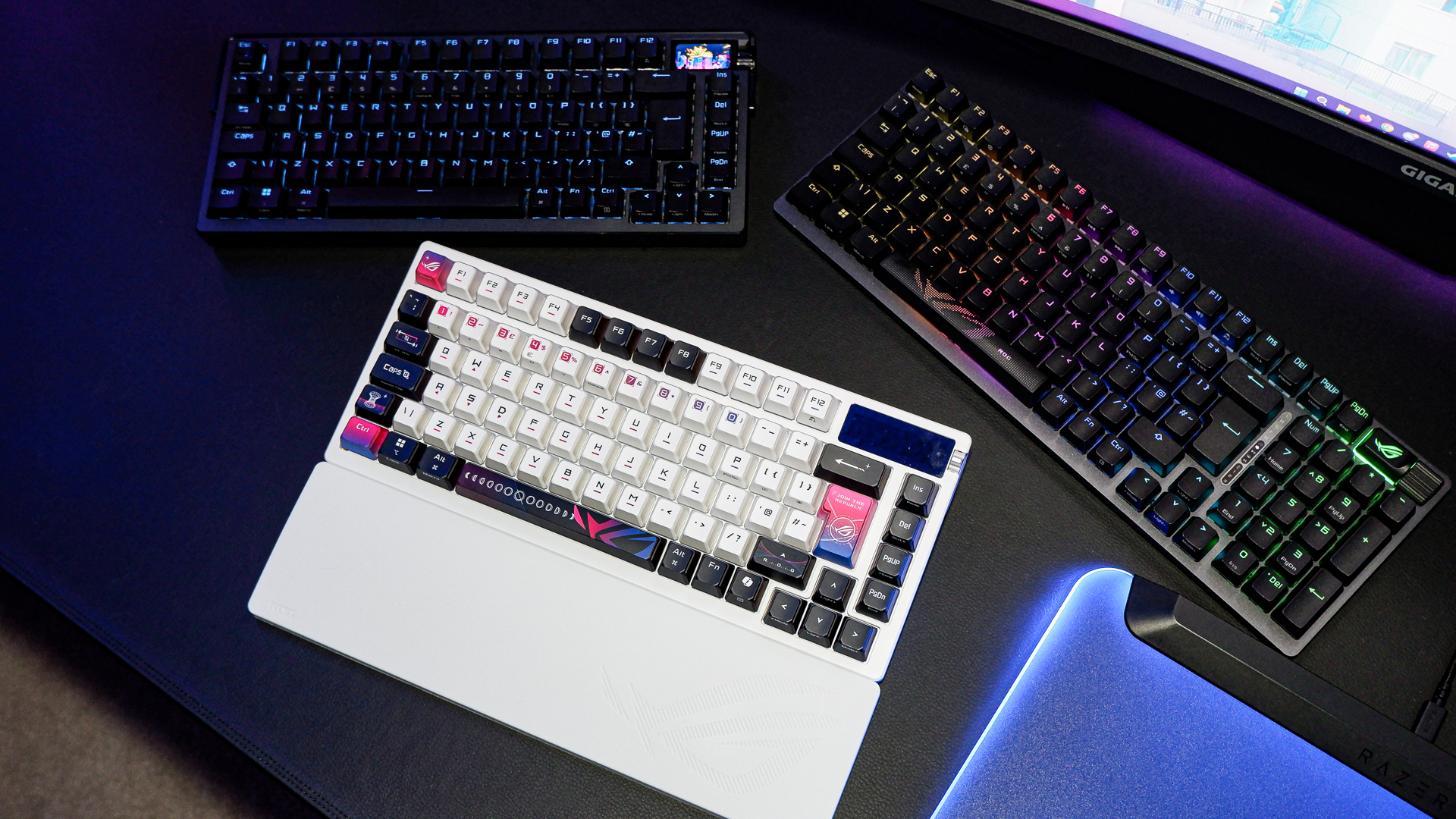 An Asus ROG Azoth X gaming keyboard on a desk with wrist rest and lighting enabled.