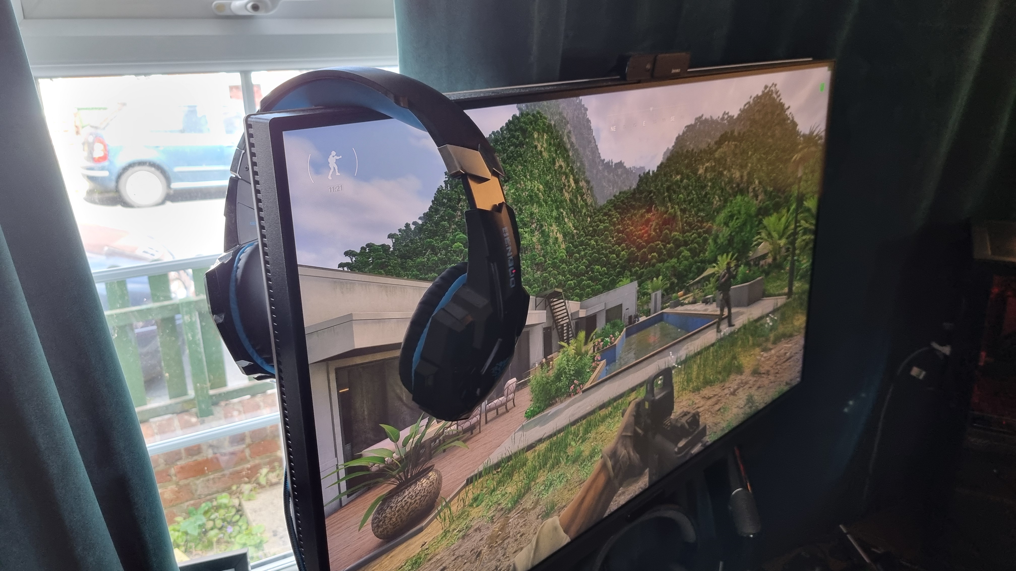 The Bengoo G9000 gaming headset on top of a 32-inch monitor, playing Gray Zone Warfare