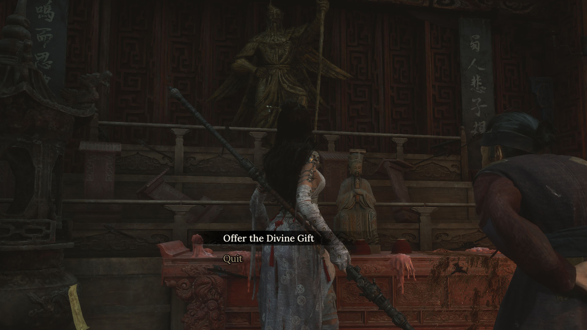 A Wuchang: Fallen Feathers screenshot showing the main character interacting with a statue. You can see a menu giving the player the option to offer the Divine Gift to the statue. There’s a old lady beside the main character. A Wuchang: Fallen Feathers screenshot showing the main character interacting with a statue. You can see a menu giving the player the option to offer the Divine Gift to the statue. There’s a old lady beside the main character.
