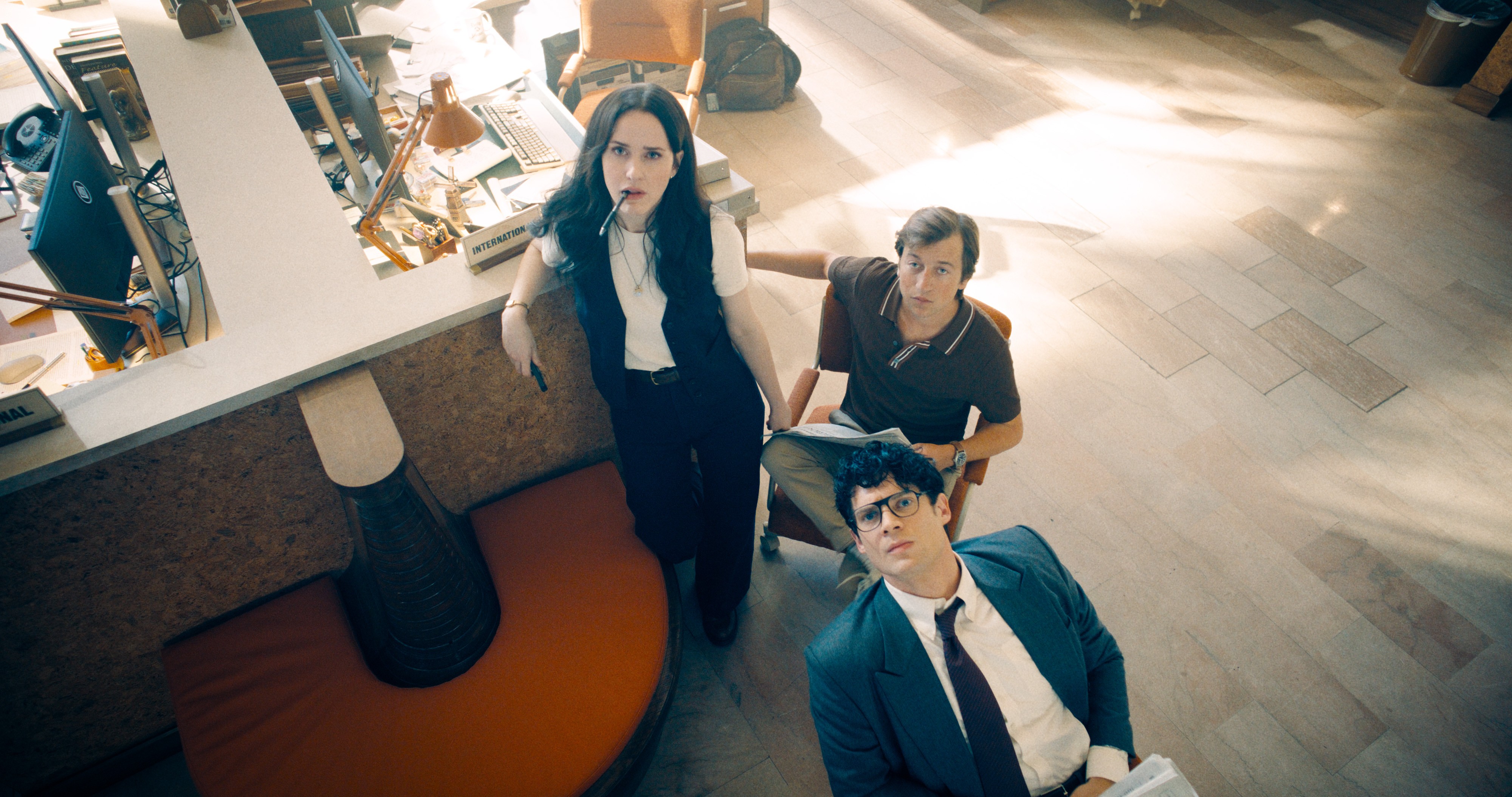 In a still from the 2025 film Superman, Lois Lane, Clark Kent, and Jimmy Olsen gather in the offices of the Daily Planet. 