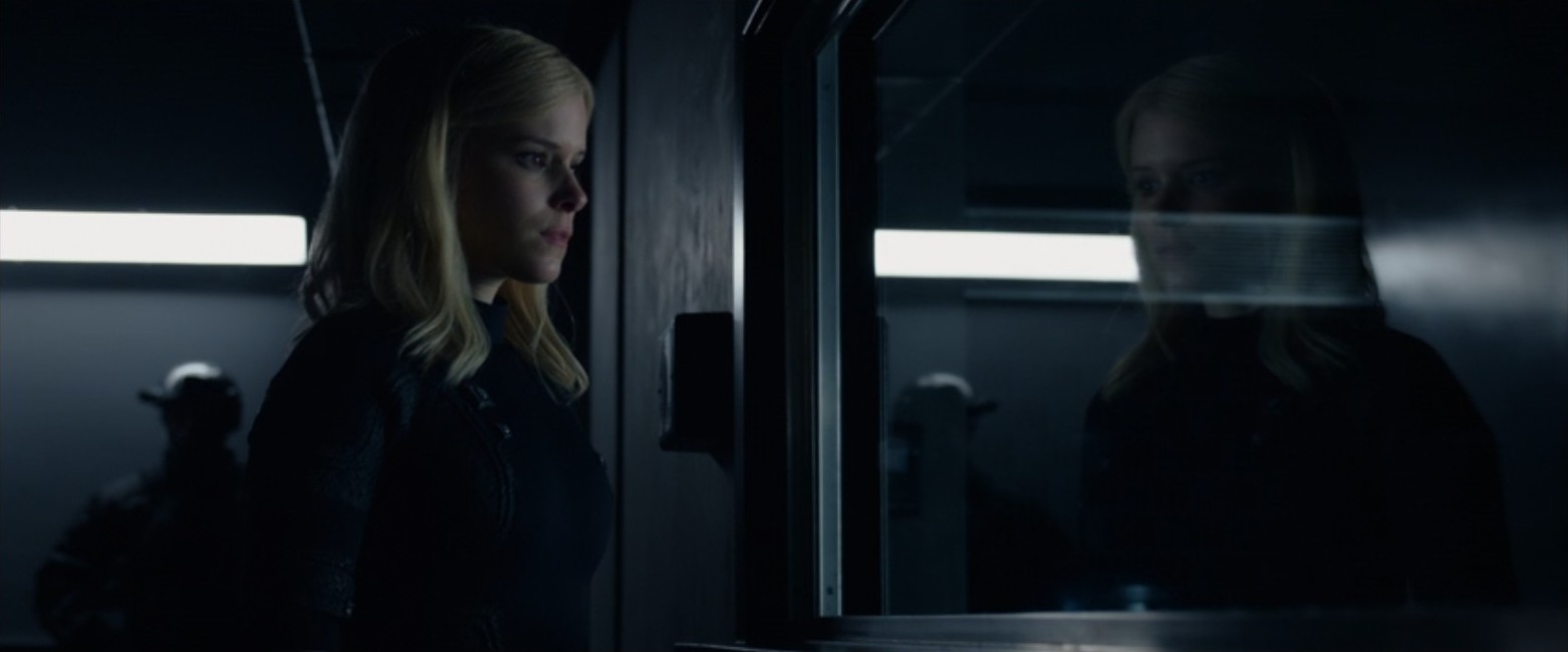 Sue Storm (Kate Mara) looks at her reflection in a military facility window in this scene from the 2015 Fantastic Four. Sue Storm (Kate Mara) looks at her reflection in a military facility window in this scene from the 2015 Fantastic Four.