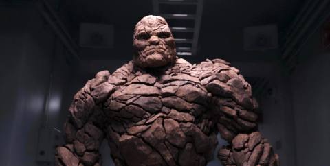 Ben Grimm in full rocky Thing mode in Josh Trank’s 2015 Fantastic Four, standing silhouetted against a dark space