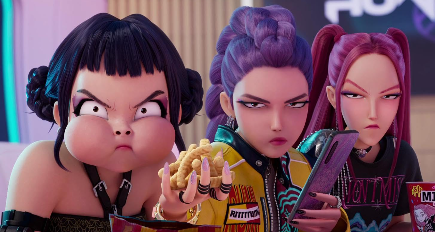 Three young women glare. The first has food in her mouth, the second holds a phone and the third a cup of ramyeon. They look distinctly unimpressed. From Netflix’s K-Pop Demon Hunters. Three young women glare. The first has food in her mouth, the second holds a phone and the third a cup of ramyeon. They look distinctly unimpressed. From Netflix’s K-Pop Demon Hunters.