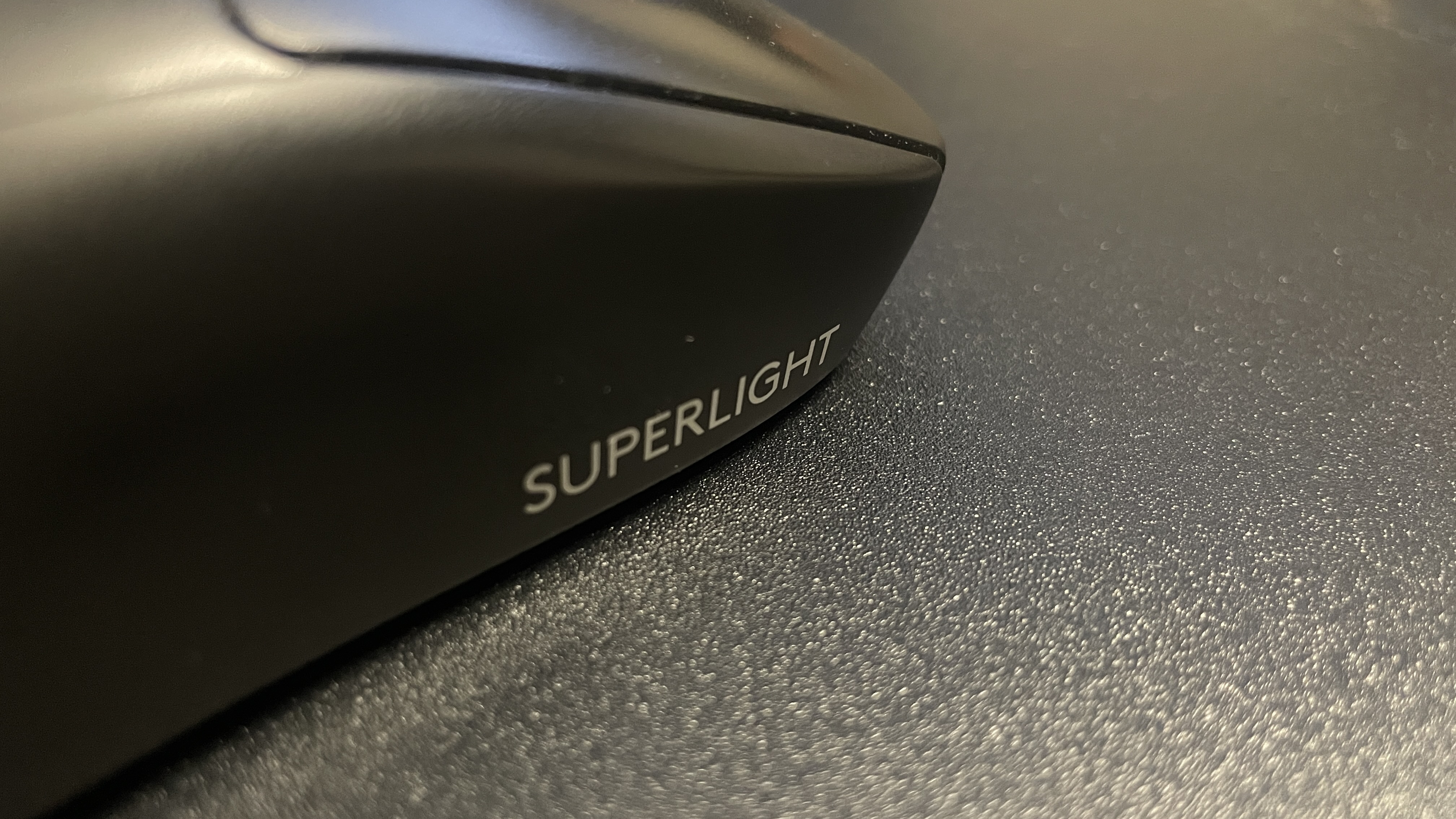 Close-up of a Logitech G Pro X Superlight gaming mouse's 'Superlight' logo