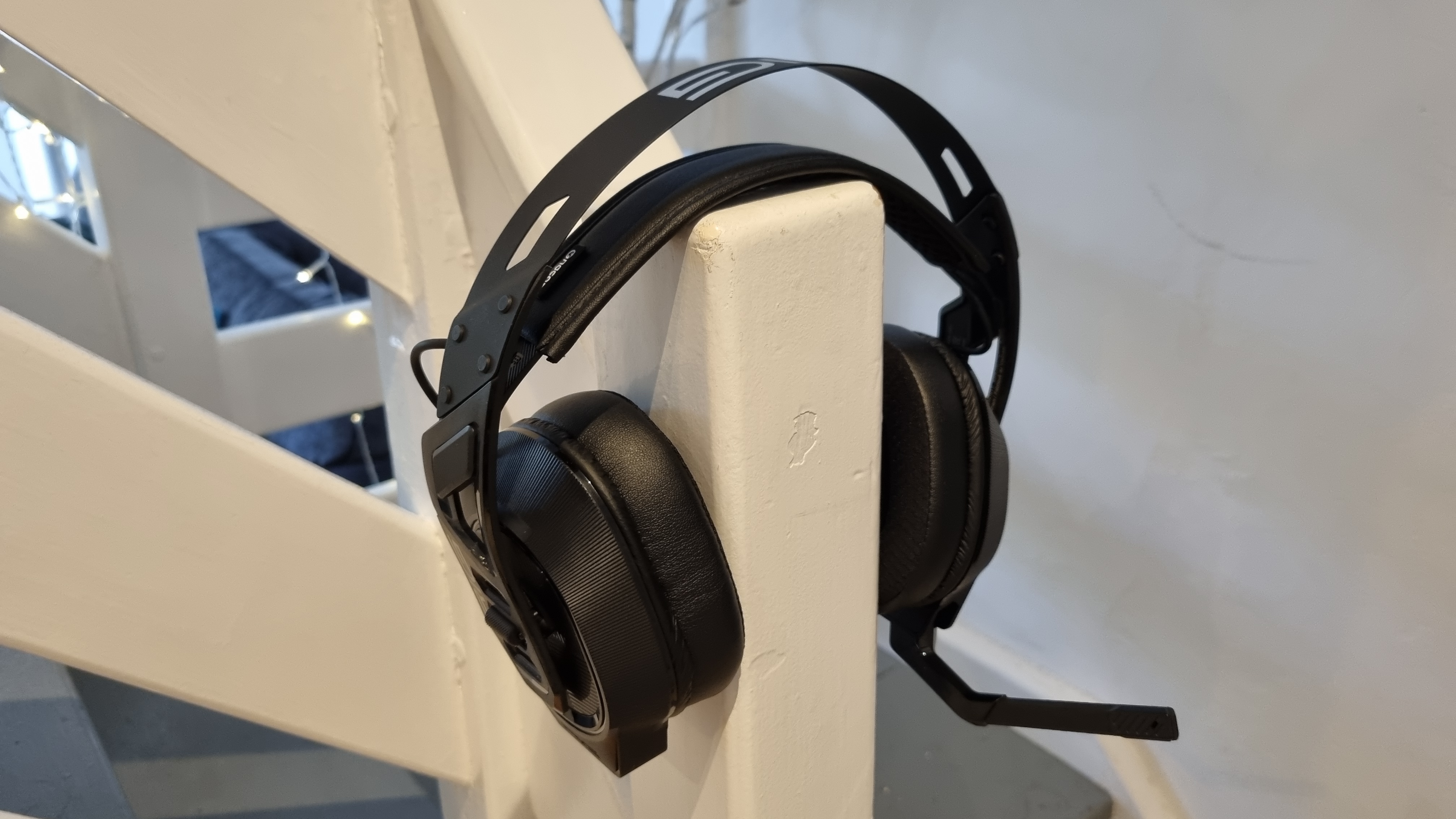 The Nacon Rig 900 Max HS on a stair banister, showing how it would look if it were being worn