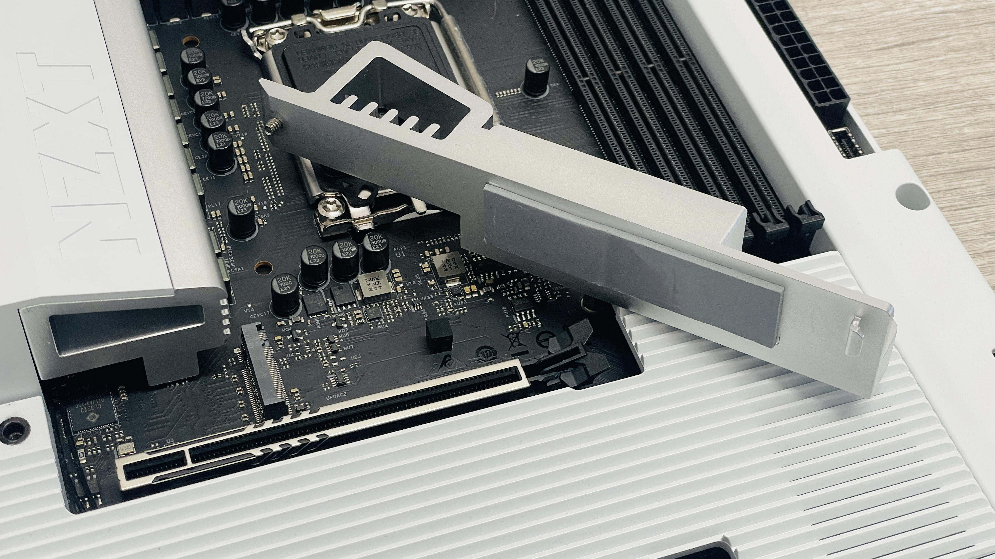 An NZXT N7 Z890 motherboard on a desk with port covers removed.
