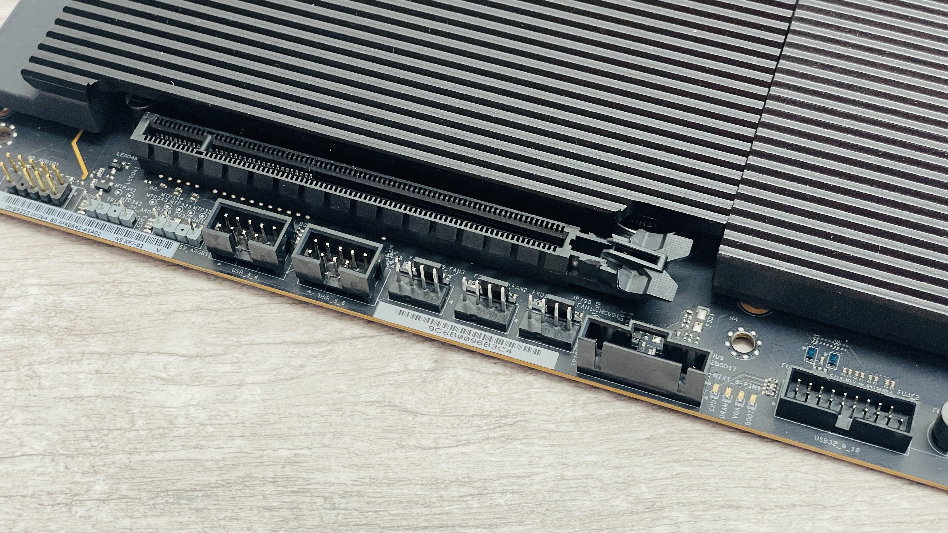 An NZXT N9 X870E motherboard in black with the port covers removed.