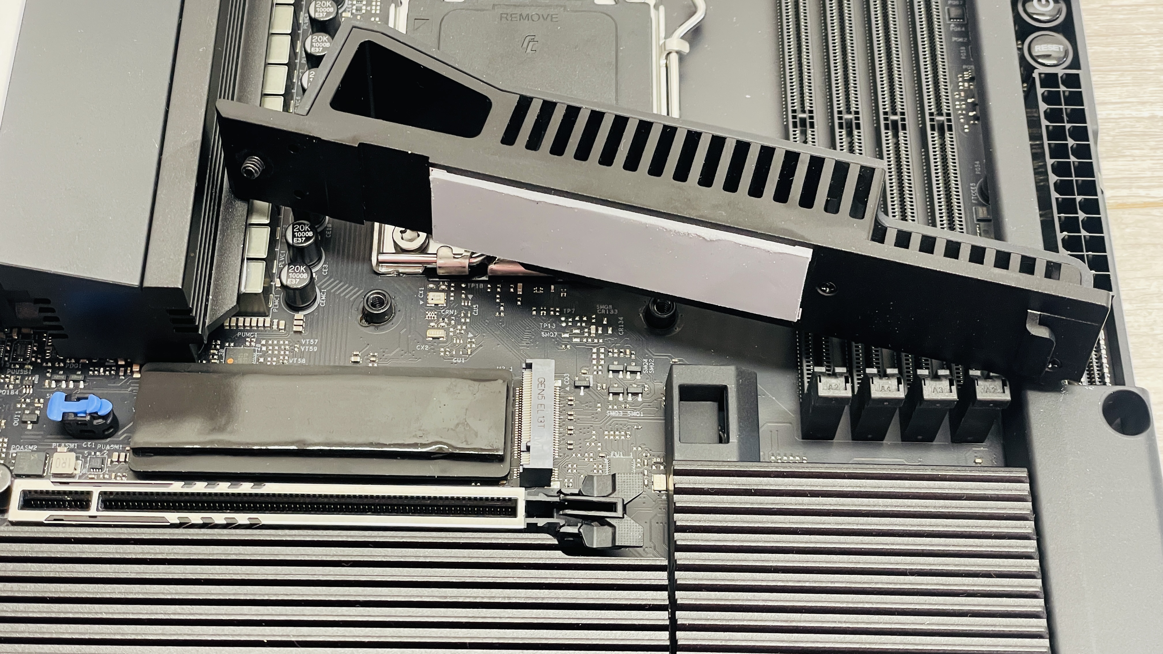 An NZXT N9 X870E motherboard in black with the port covers removed.