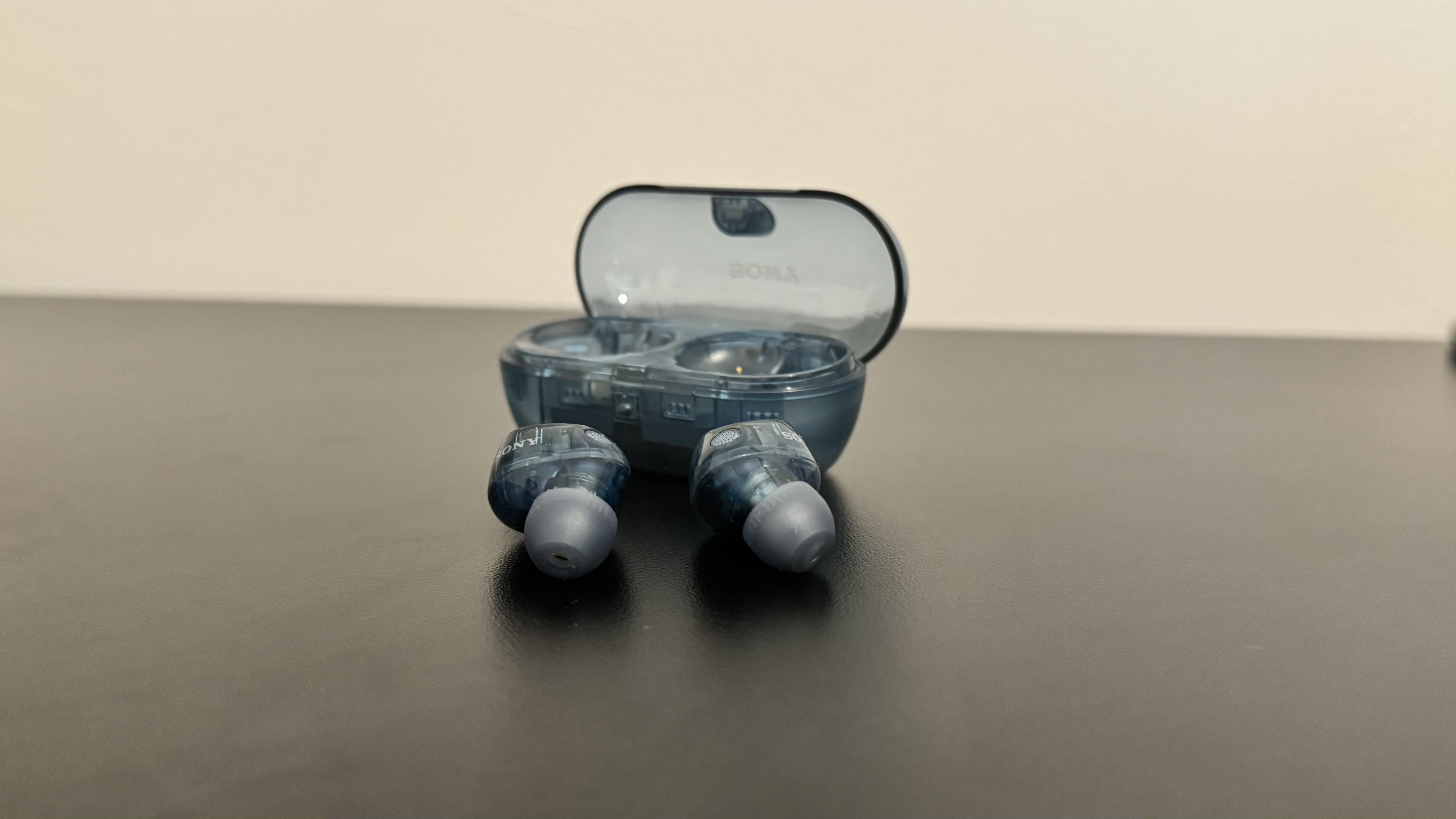 Sony WF-C710N earbuds in front of the charging case