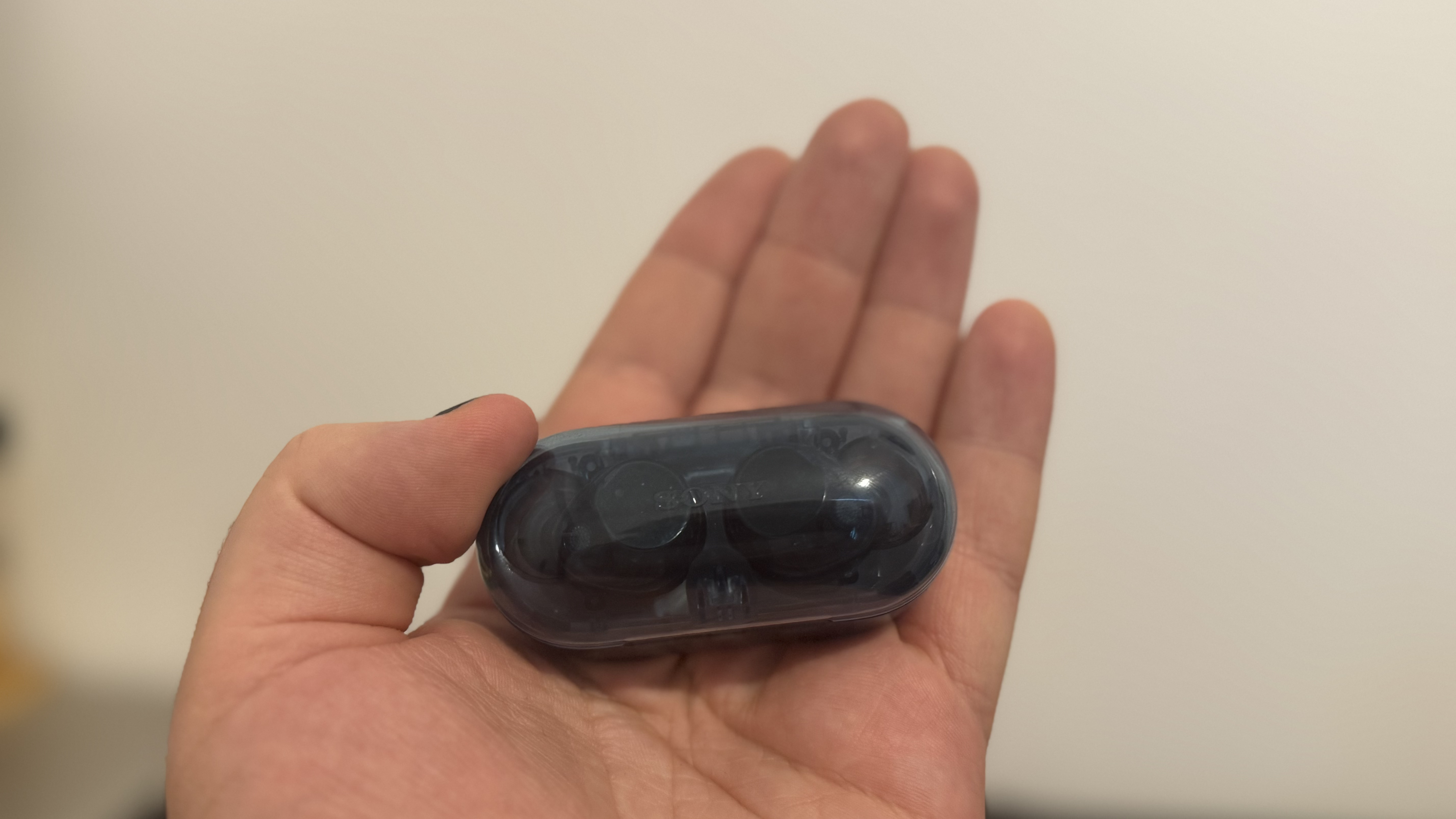 Sony WF-C710N earbuds in a hand