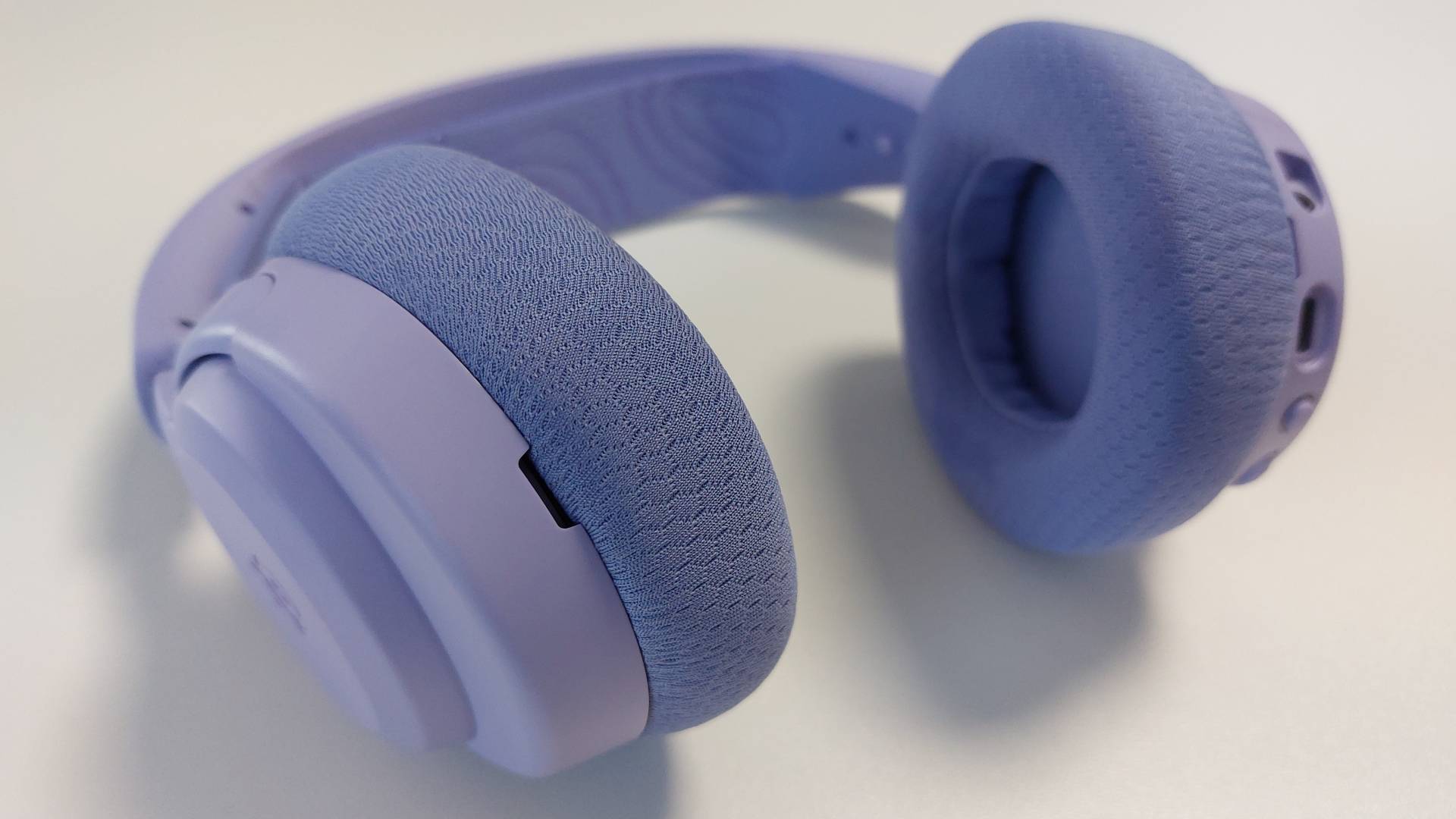 The SteelSeries Arctis Nova 3 X seen on a desk. This is the Lavender colourway.