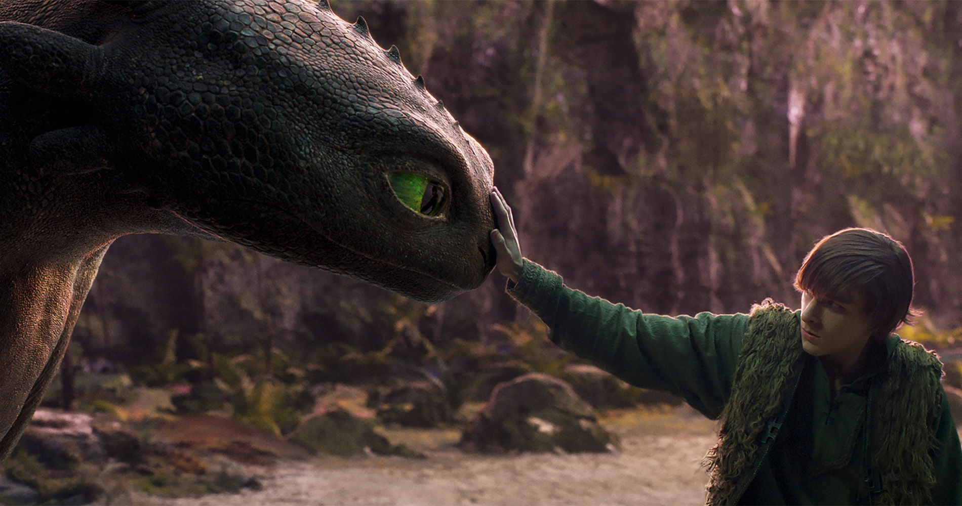 Hiccup (Mason Thames) hesitantly reaches out to touch the snout of Toothless the black dragon in the live-action How to Train Your Dragon Hiccup (Mason Thames) hesitantly reaches out to touch the snout of Toothless the black dragon in the live-action How to Train Your Dragon