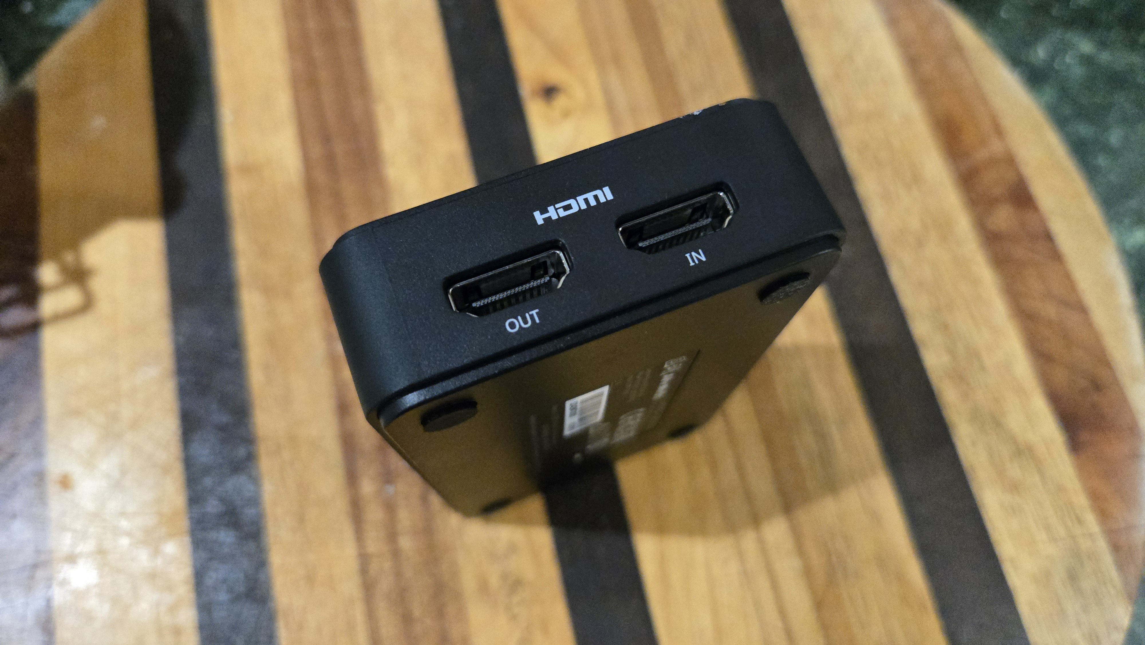 An AverMedia external capture card on a chair.