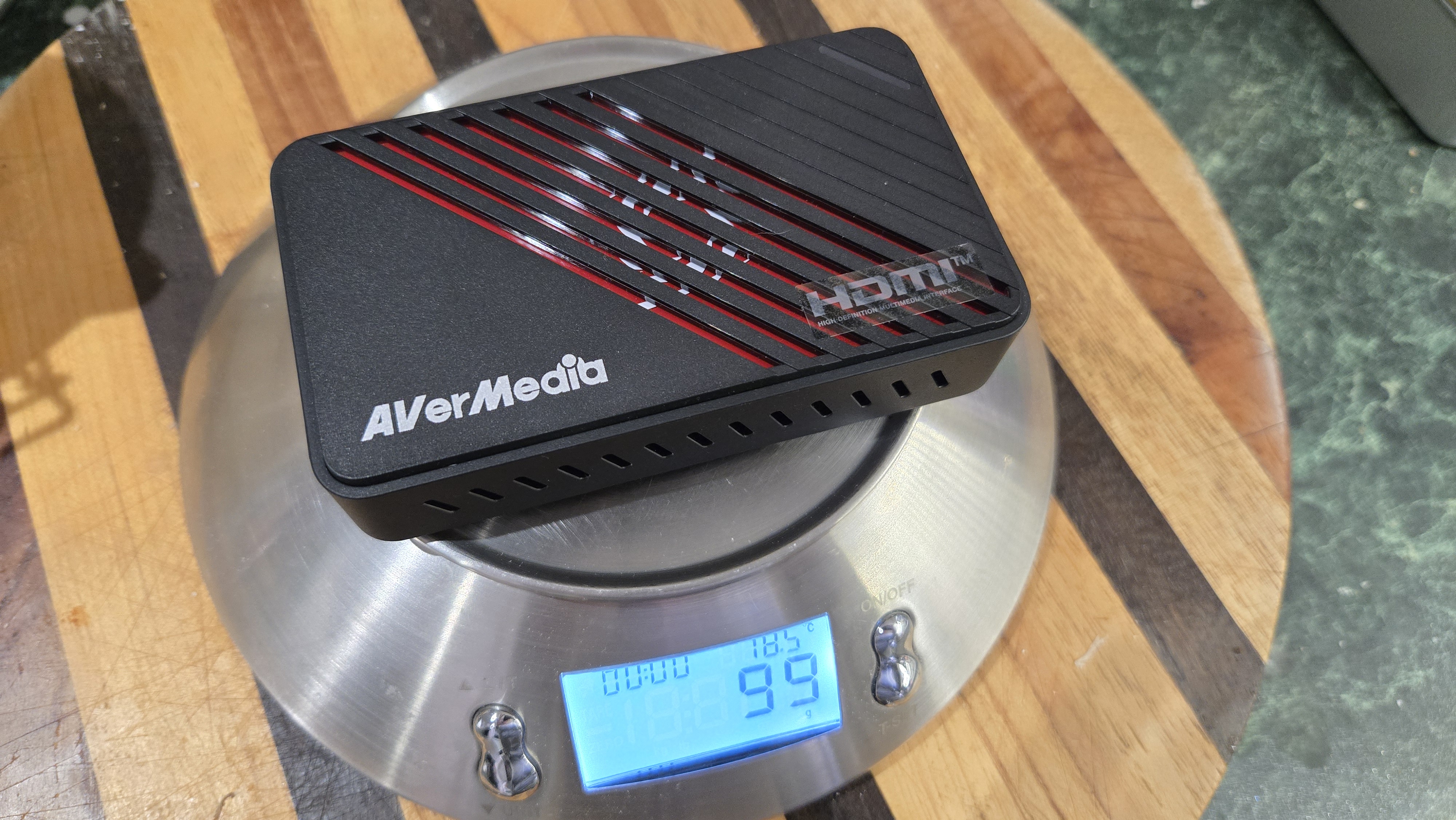 An AverMedia external capture card on a chair.