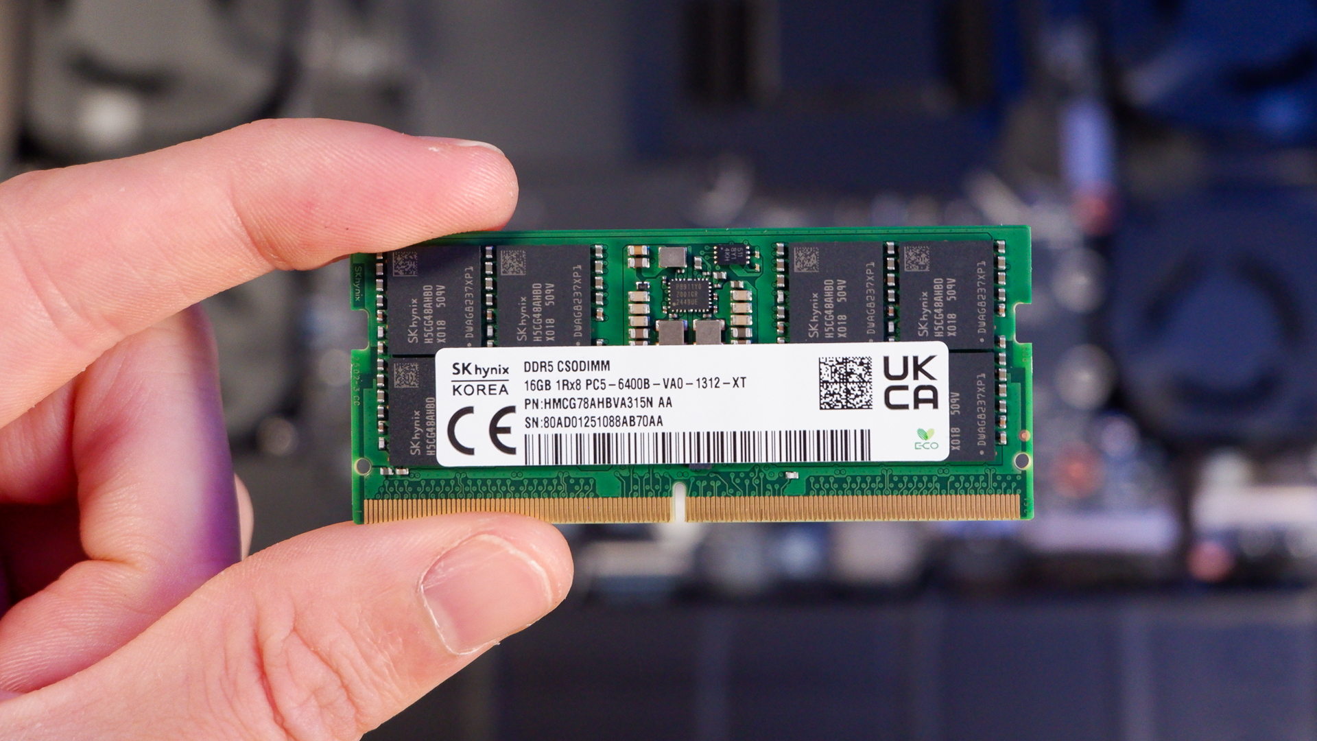 An Alienware 16 Area-51 gaming laptop with RGB lighting in blue on a desk mat.