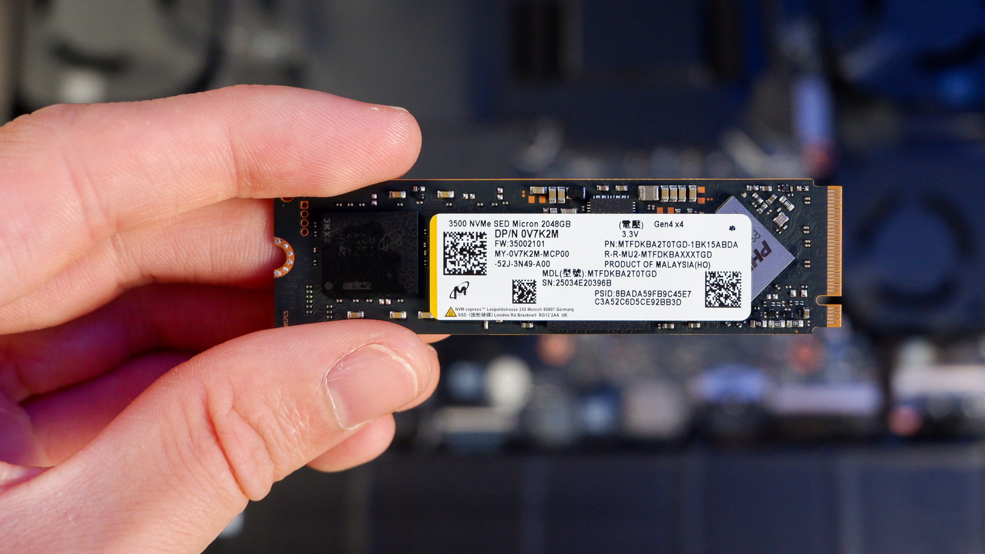 An Alienware 16 Area-51 gaming laptop with RGB lighting in blue on a desk mat.