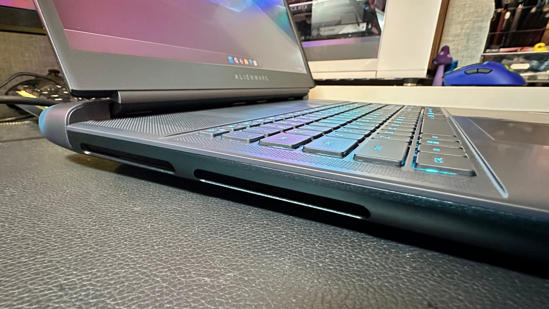 A close-up photo of the left side of the Alienware 18 Area-51 gaming laptop, showing the exhaust vents for the cooling system