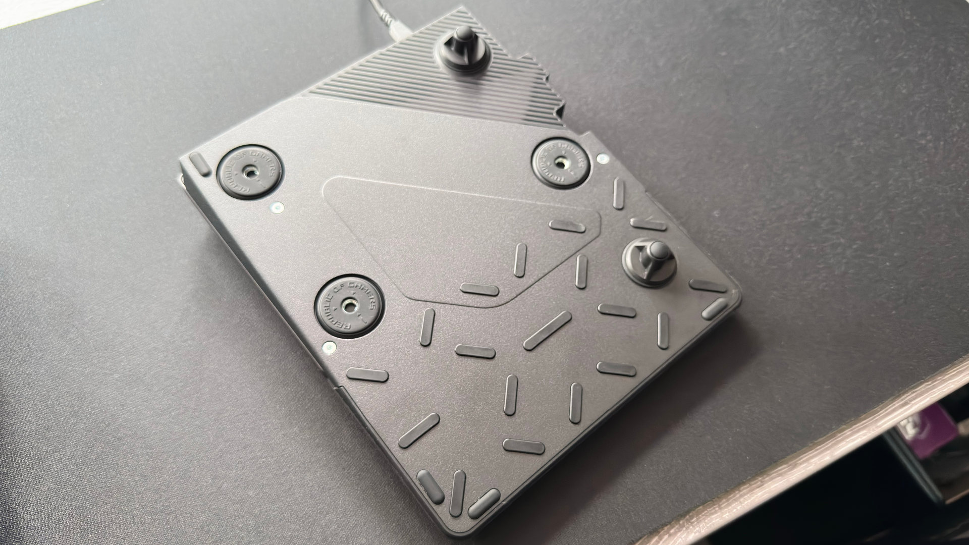 A photo of the underside of an Asus ROG Falcata gaming keyboard, with the optional wristpad installed