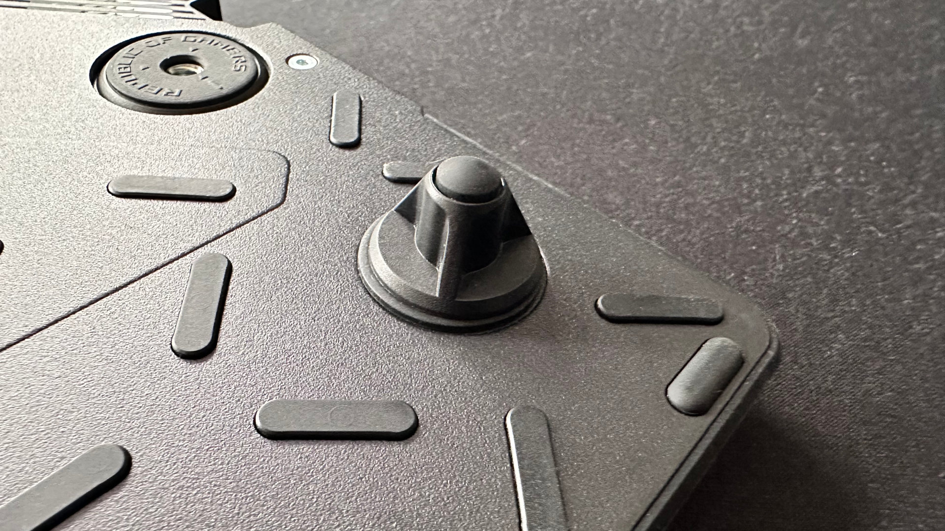 A close-up photo of the optional tenting/tilting feet for the Asus ROG Falcata gaming keyboard