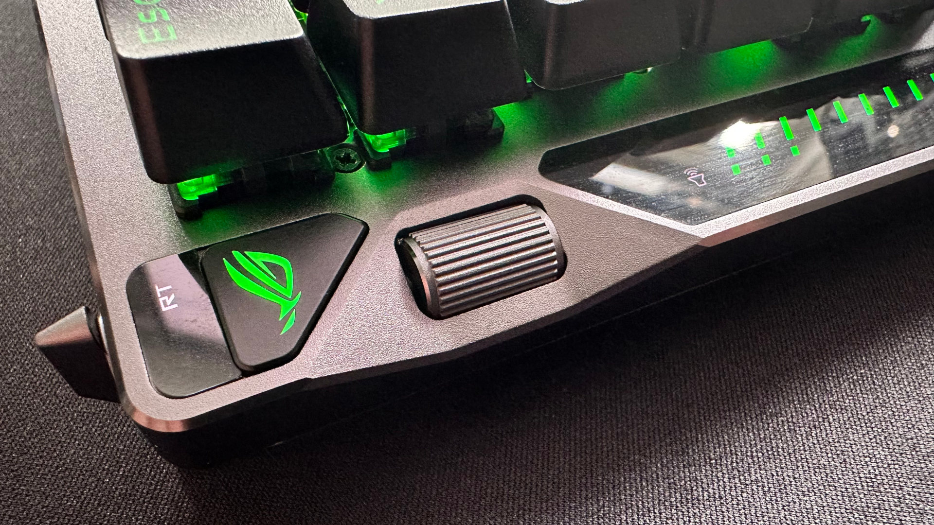 A close-up photo of the Asus ROG Falcata gaming keyboard, showing the multifunction control wheel