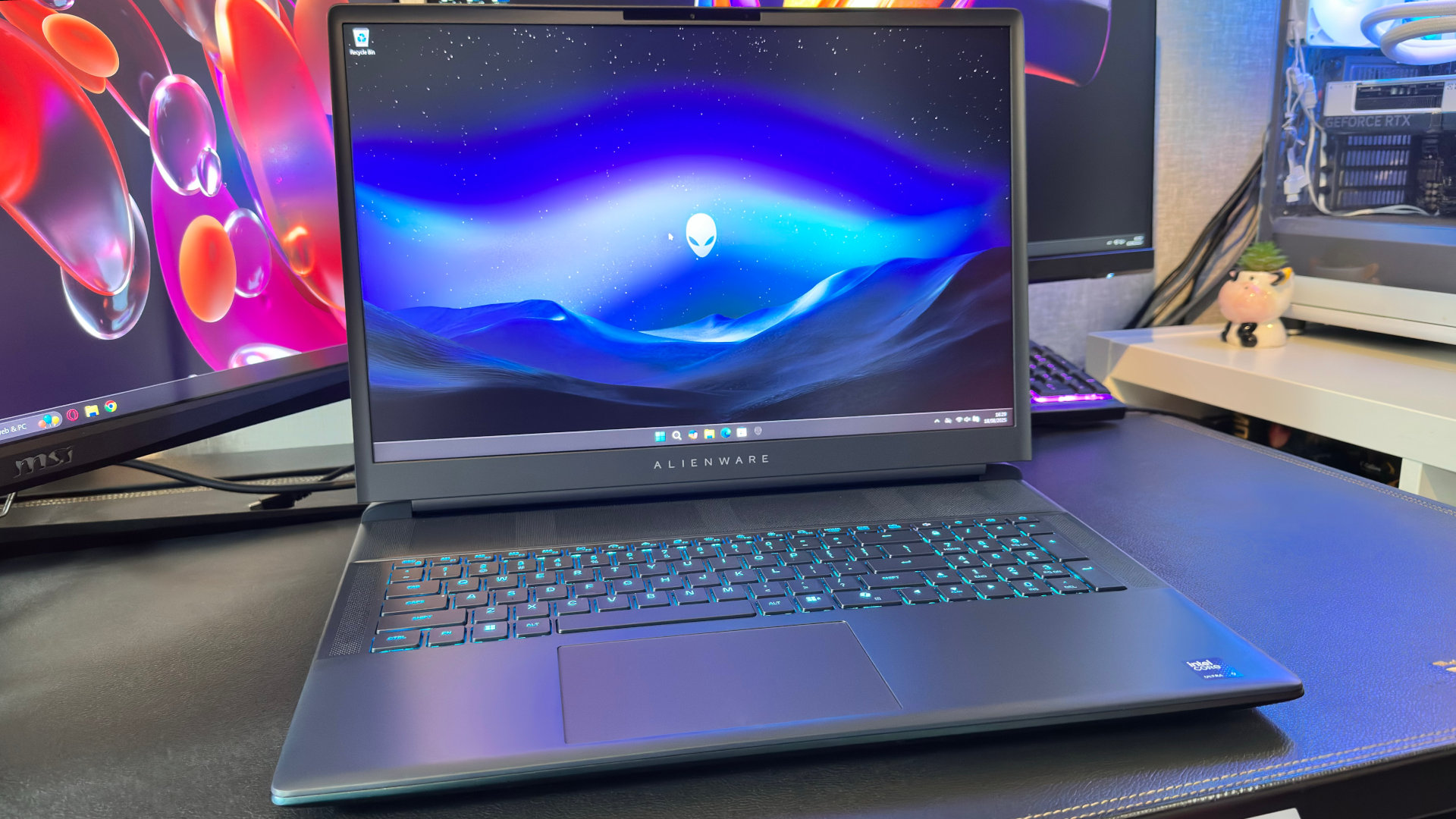 A photo of the keyboard of the Alienware 18 Area-51 gaming laptop, with the display showing the Windows desktop