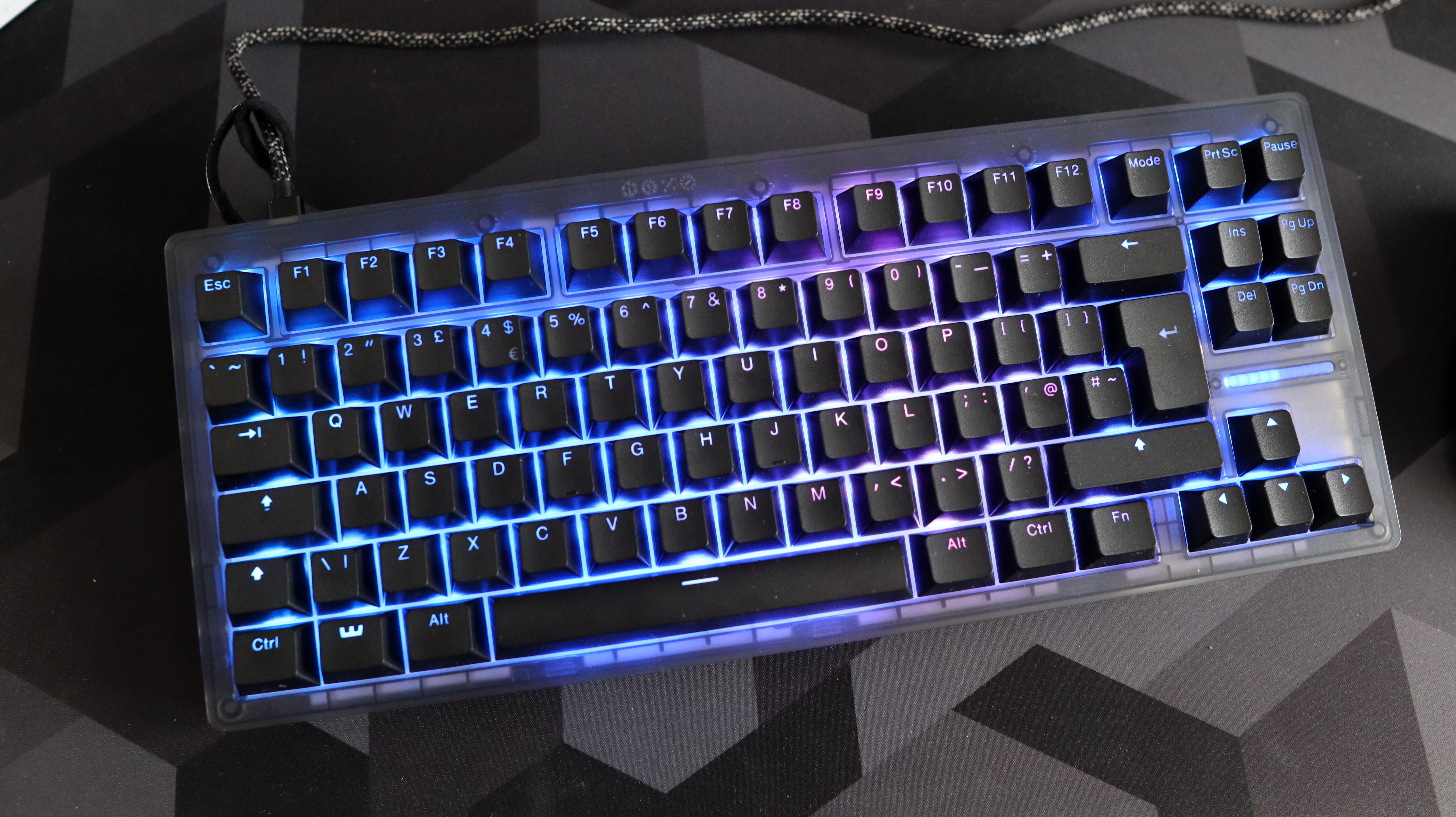 The Wooting 8-HE on a mouse pad with RGB lighting enabled.