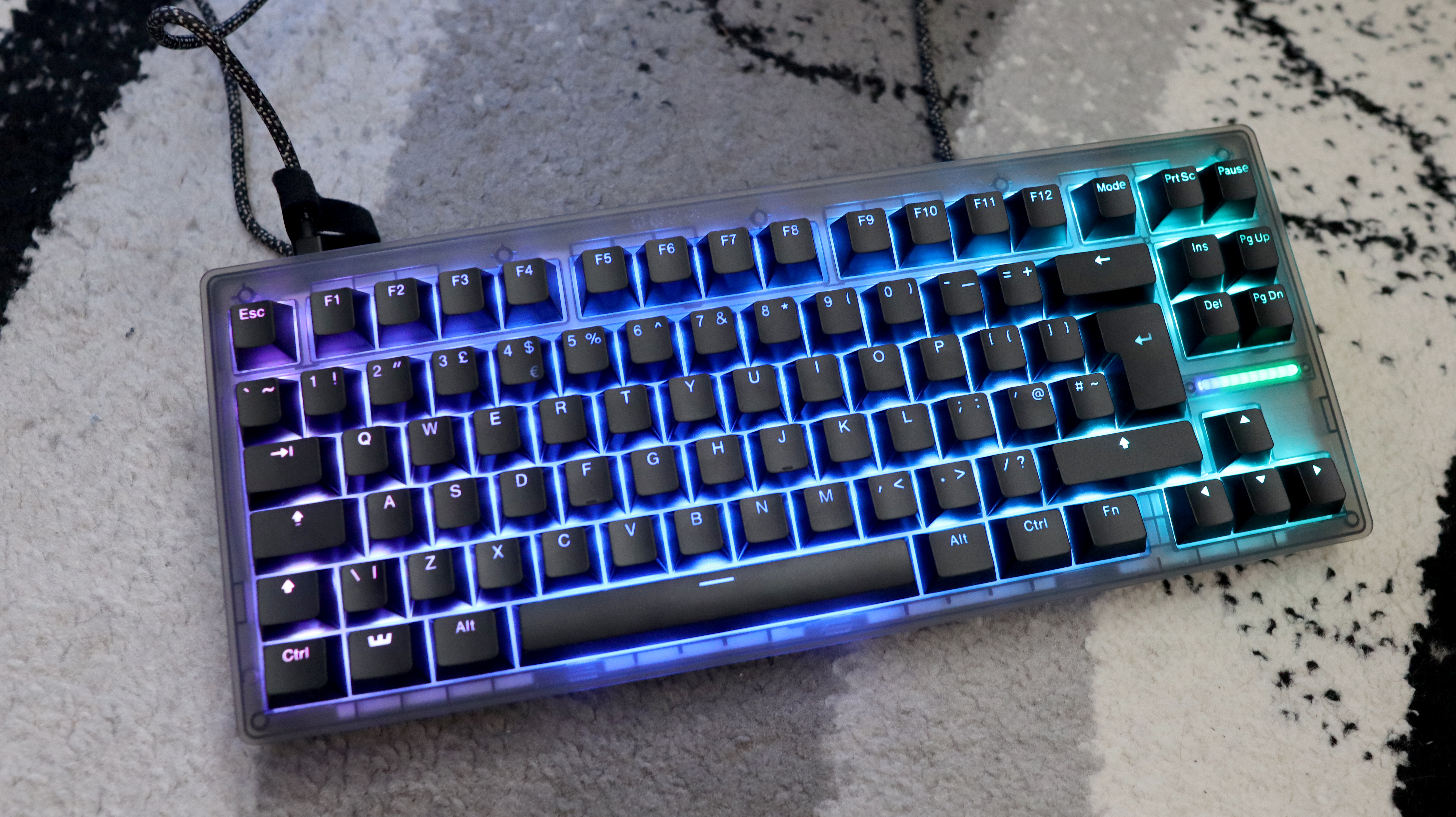 The Wooting 8-HE on a mouse pad with RGB lighting enabled.