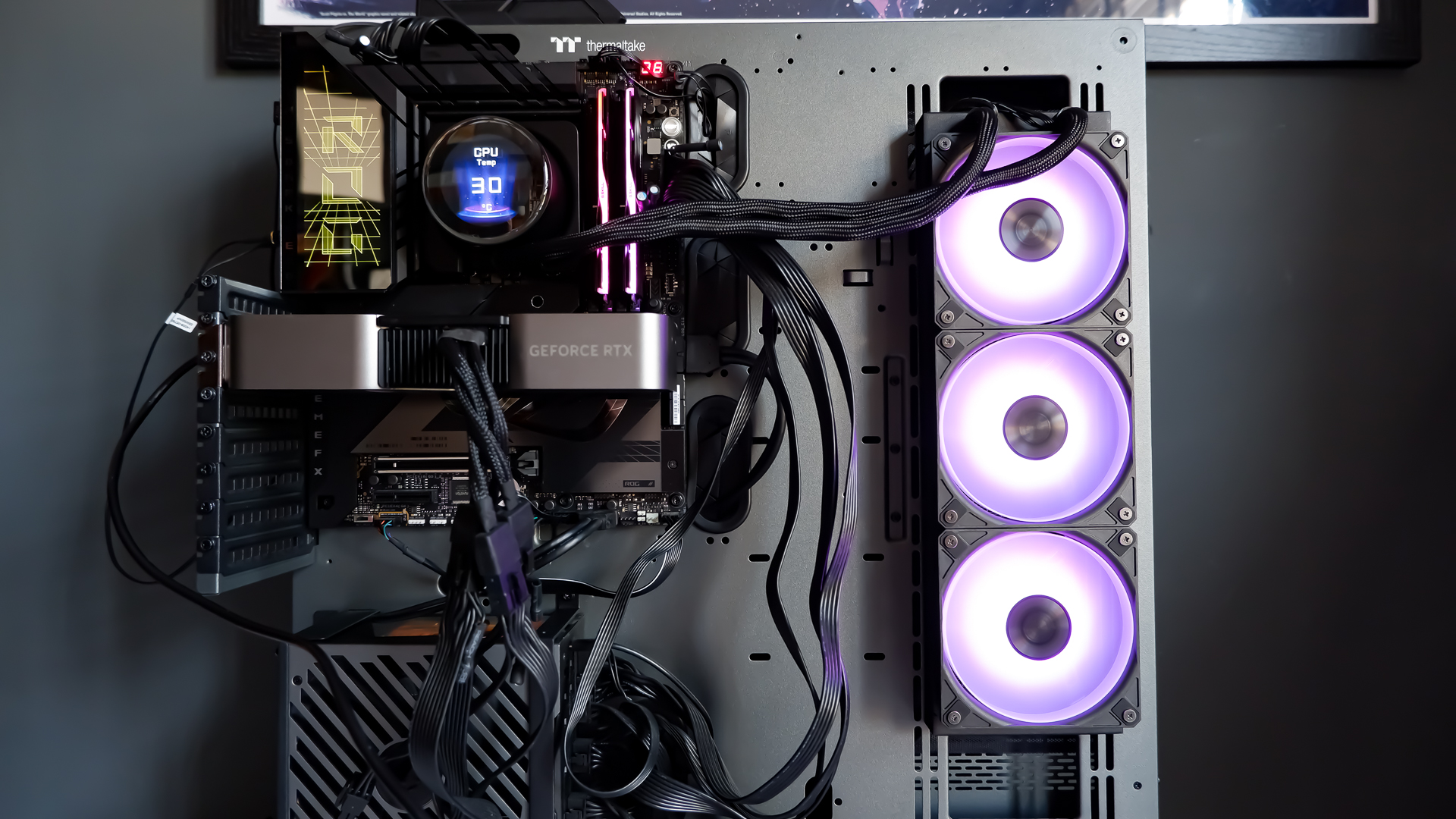 An MSI MPG CoreLiquid P13 all-in-one liquid cooler on a desk and installed onto a test bench for testing.