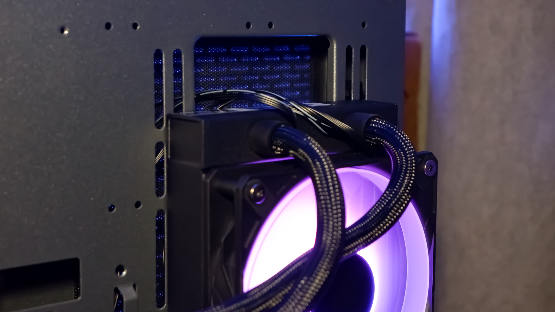 An MSI MPG CoreLiquid P13 all-in-one liquid cooler on a desk and installed onto a test bench for testing.
