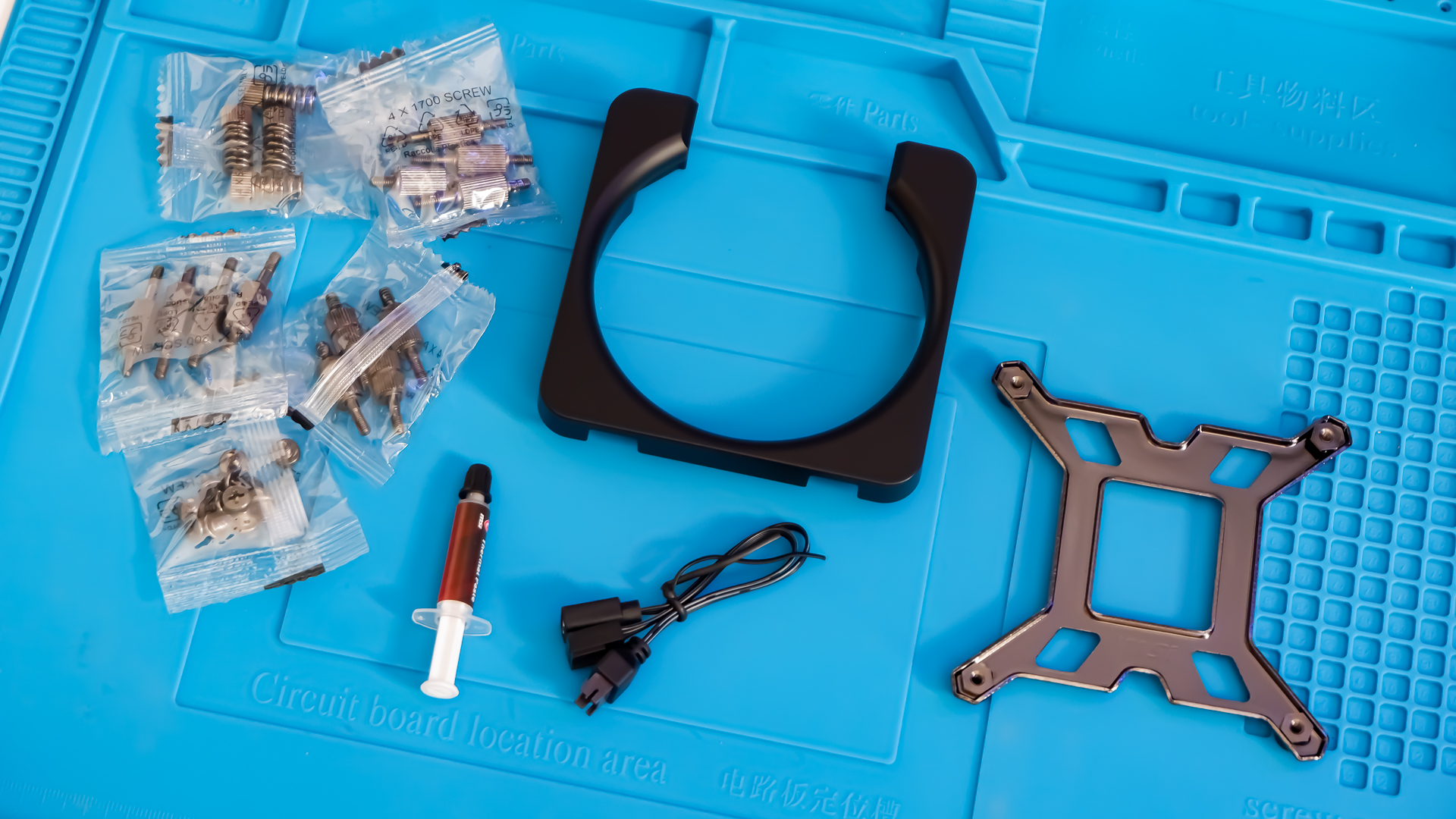 An MSI MPG CoreLiquid P13 all-in-one liquid cooler on a desk and installed onto a test bench for testing.