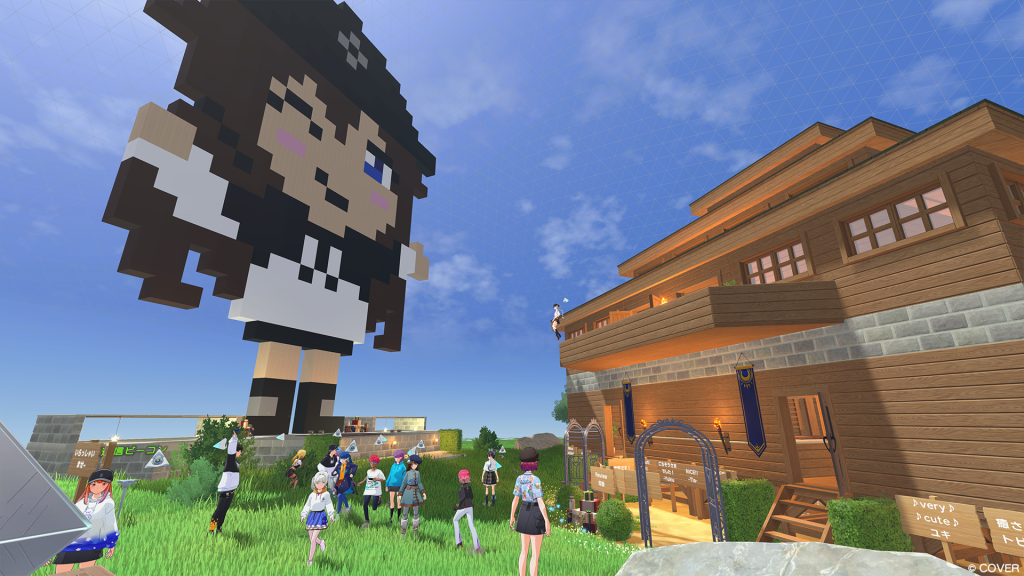 A screenshot from Holoearth, a virtual platform for vtuber fans to hang out. A group of fans popular a lawn as 3D avatars surrounding a pixel art statue of a vtuber.
