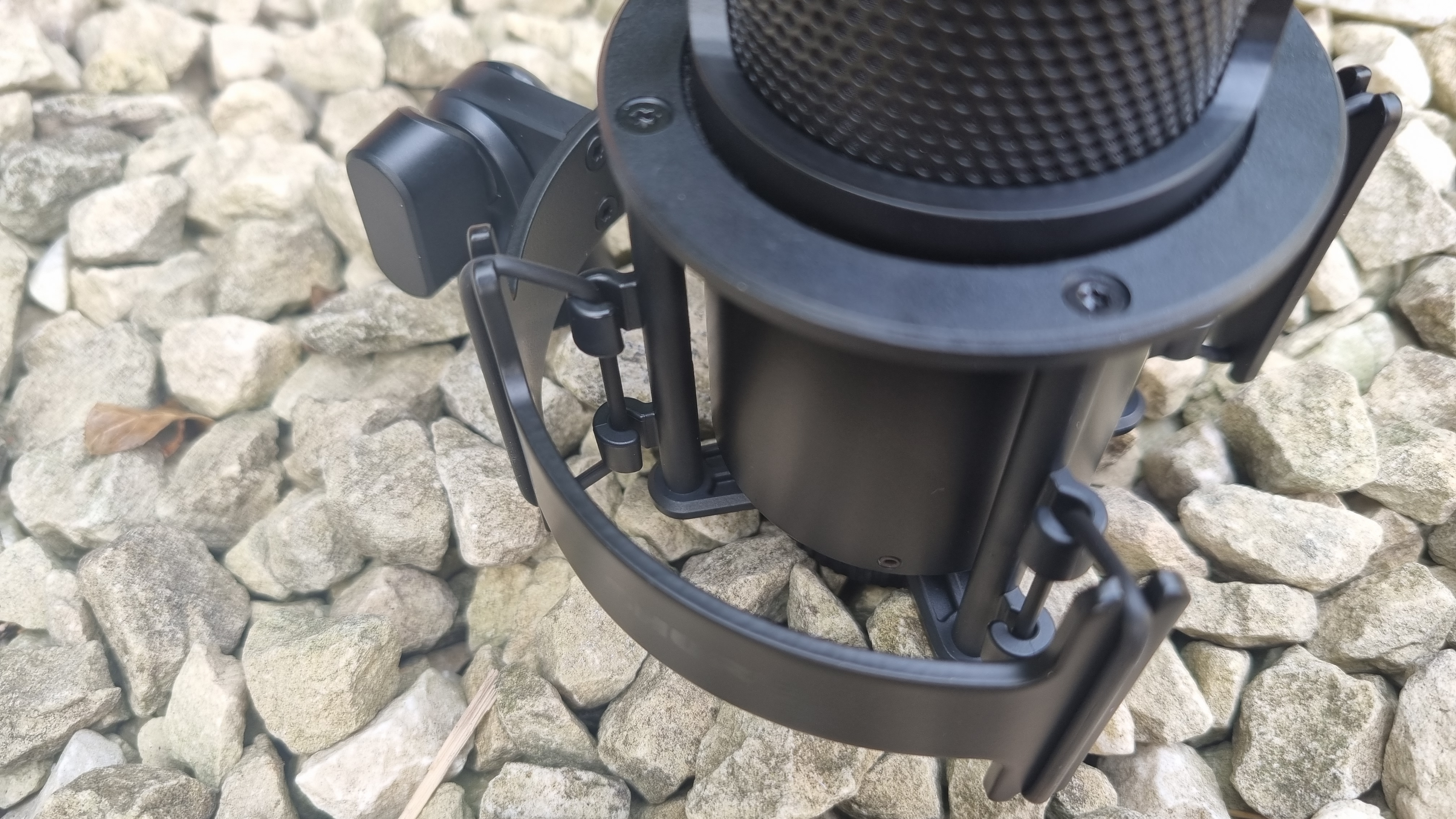 The Shure SM4 Studio Kit, shown on a white gravel background