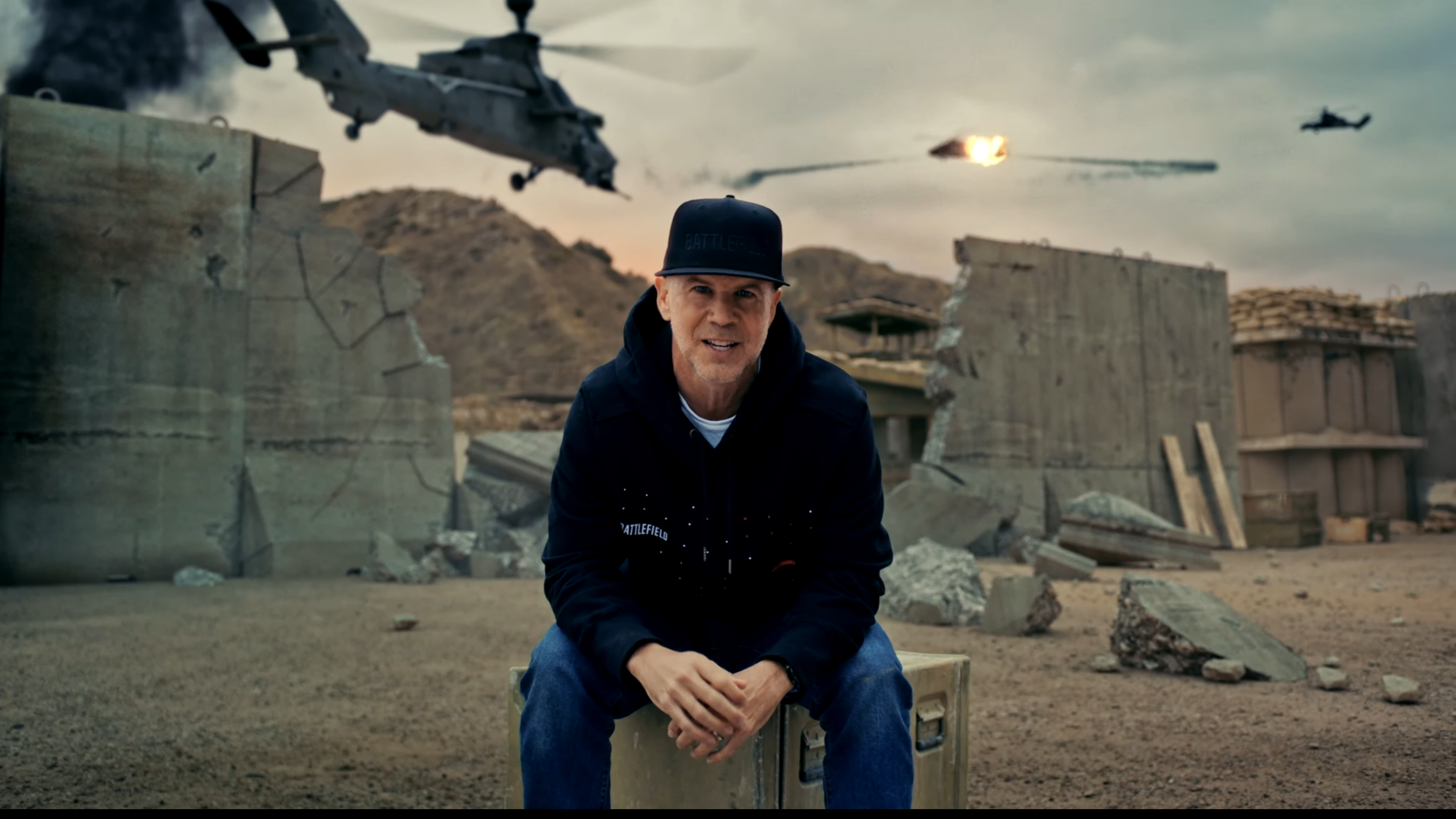 Battlefield general manager Bryson Beede in front of exploding attack helicopter in Battlefield 6 multiplayer reveal.