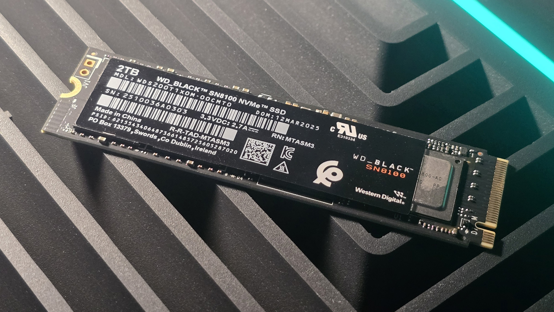 A WD Black SN8100 solid-state drive on a desk and ready to be installed.