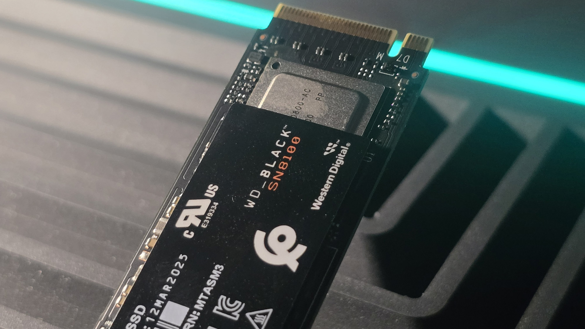 A WD Black SN8100 solid-state drive on a desk and ready to be installed.