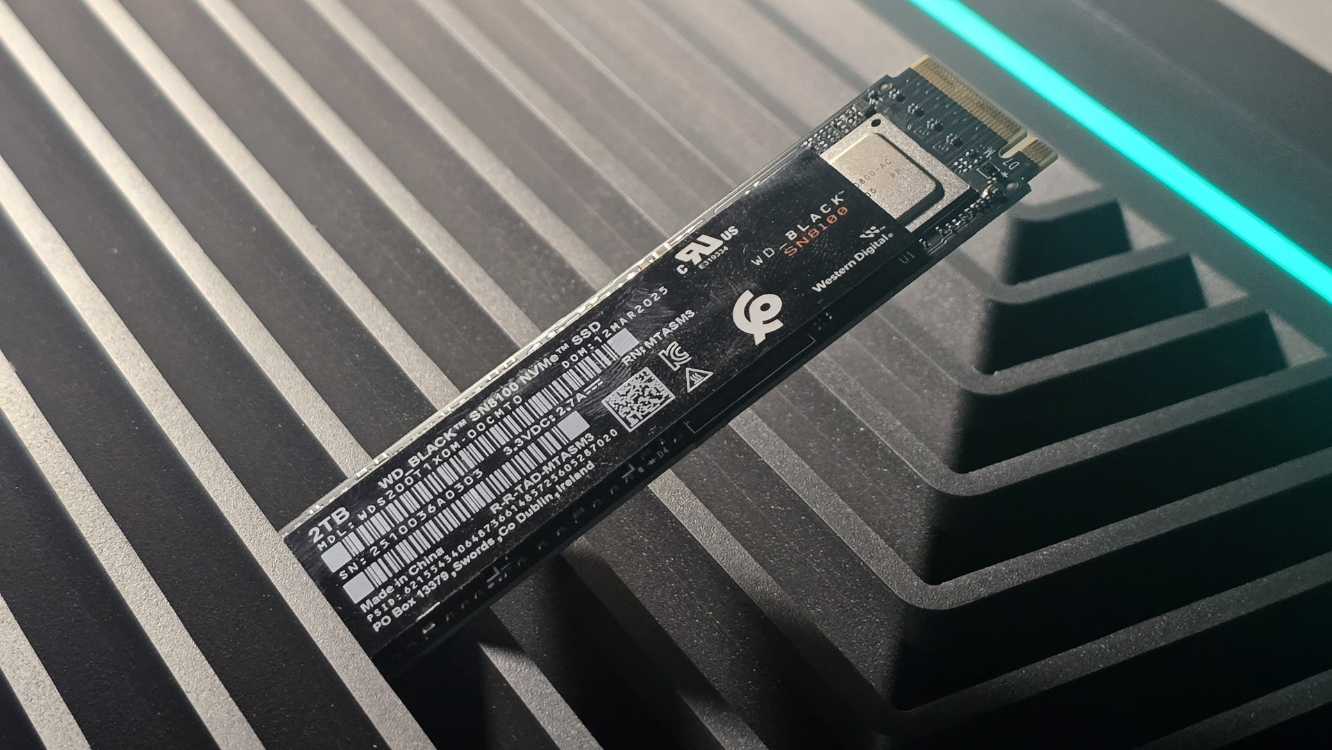 A WD Black SN8100 solid-state drive on a desk and ready to be installed.