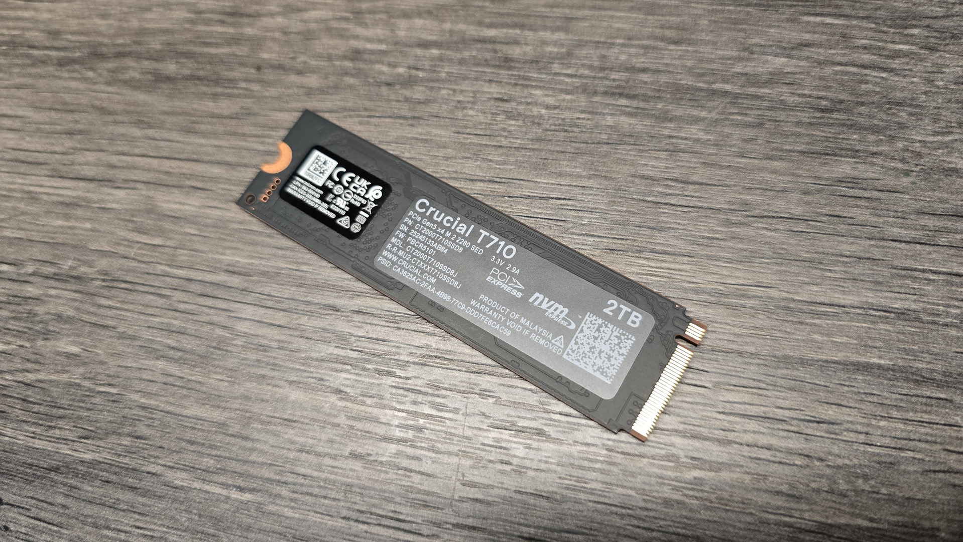 A Crucial T710 SSD on some fans ready to be installed inside a gaming PC.