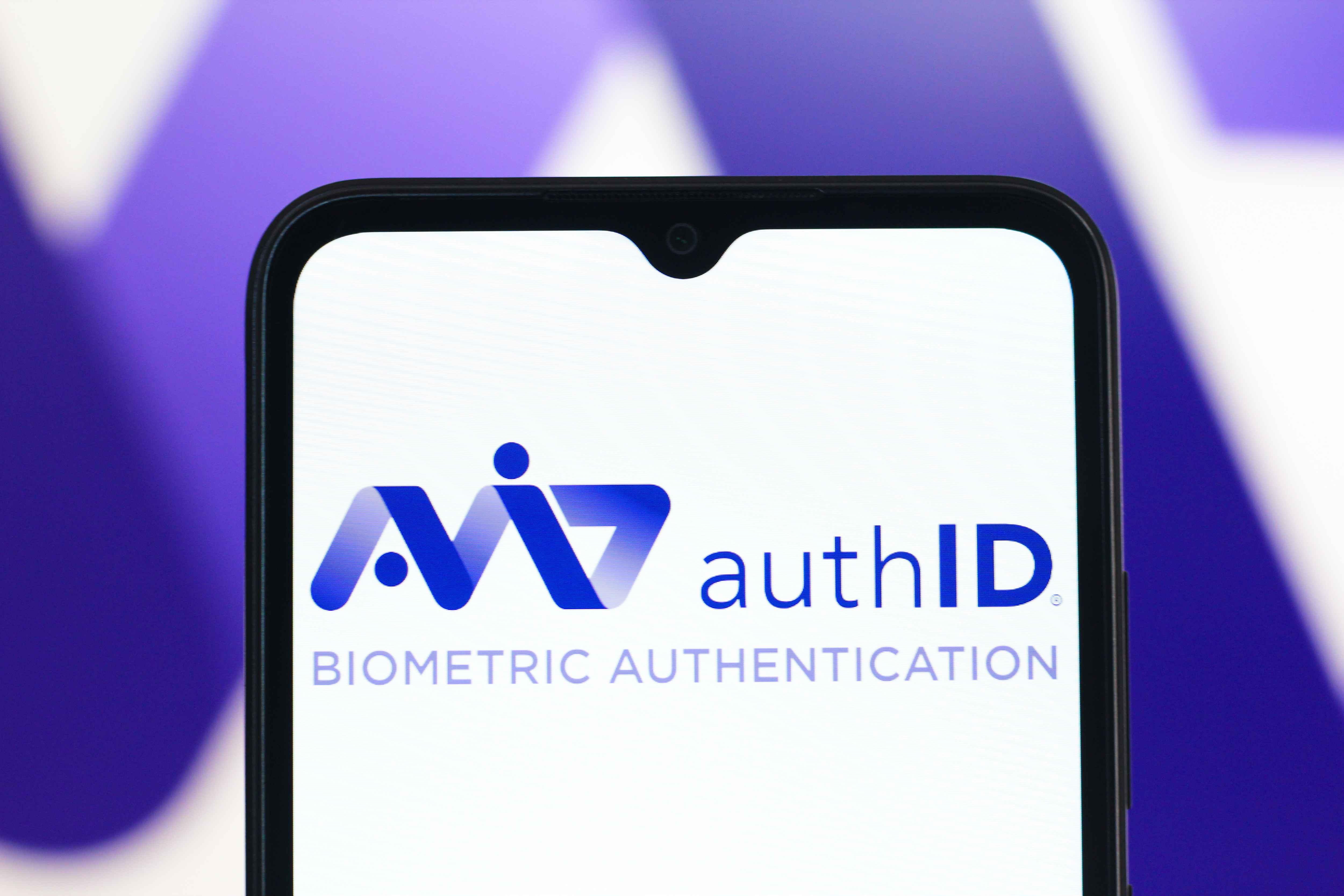 A phone screen showing AuthID biometric authentication