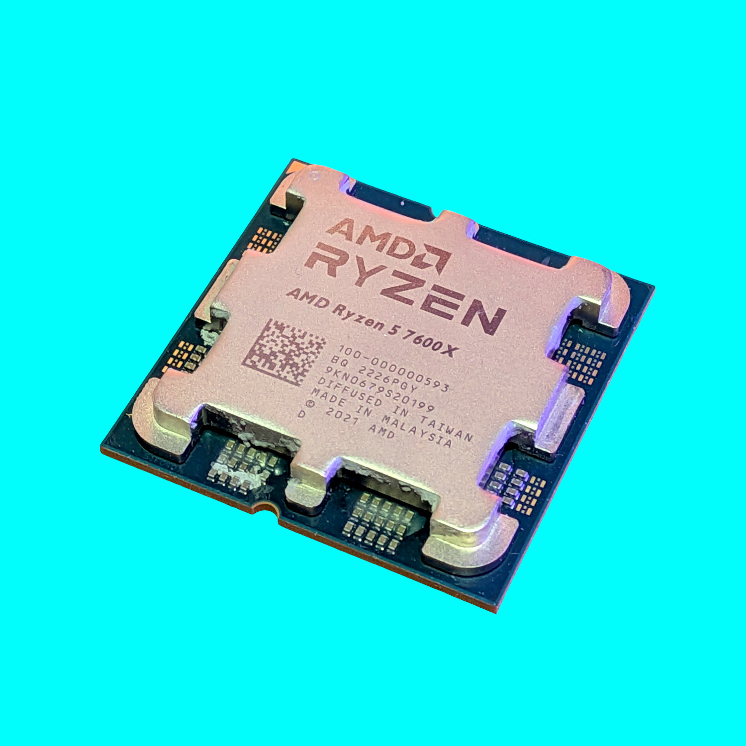 An image of an AMD Ryzen 5 7600X processor against a bright blue background.