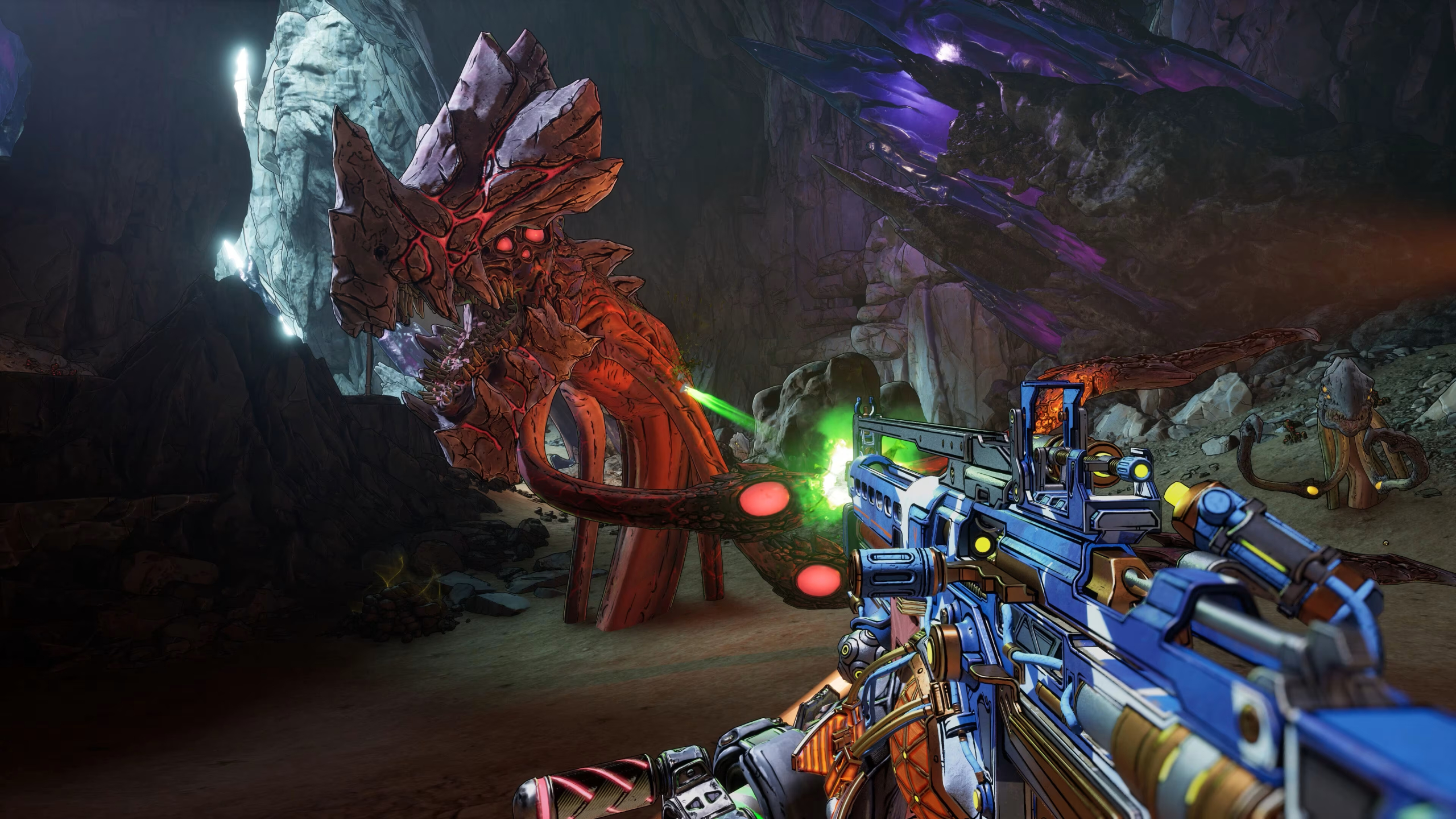 Borderlands 4 endgame preview: A screenshot of combat gameplay, showing a player shooting an assault rifle at a tentacled-creature inside a cave.