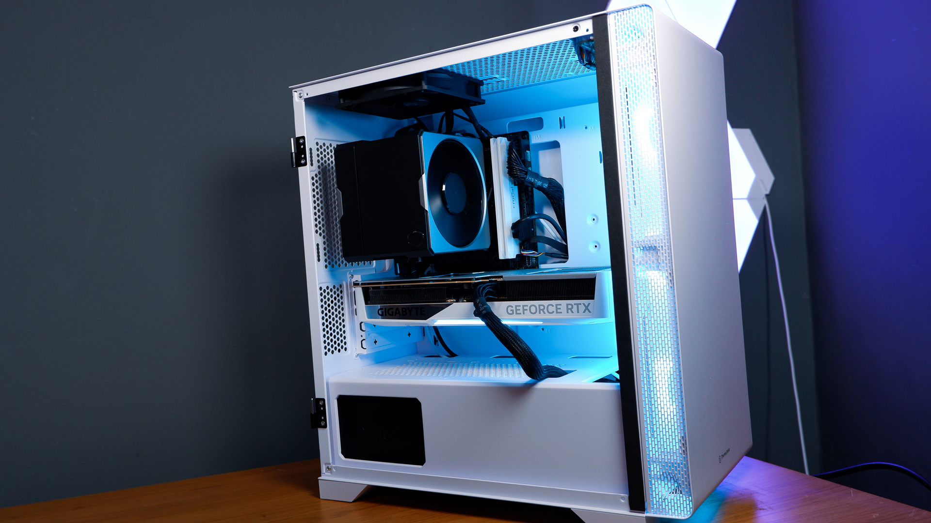 A white gaming PC built using a Thermaltake PC case, Cooler Master fans, and an AMD CPU.