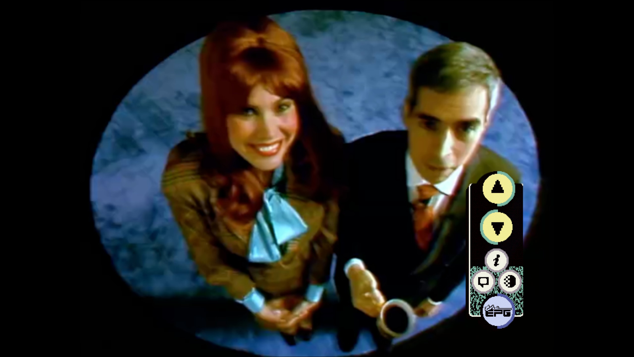 A man and a woman look up into a camera.