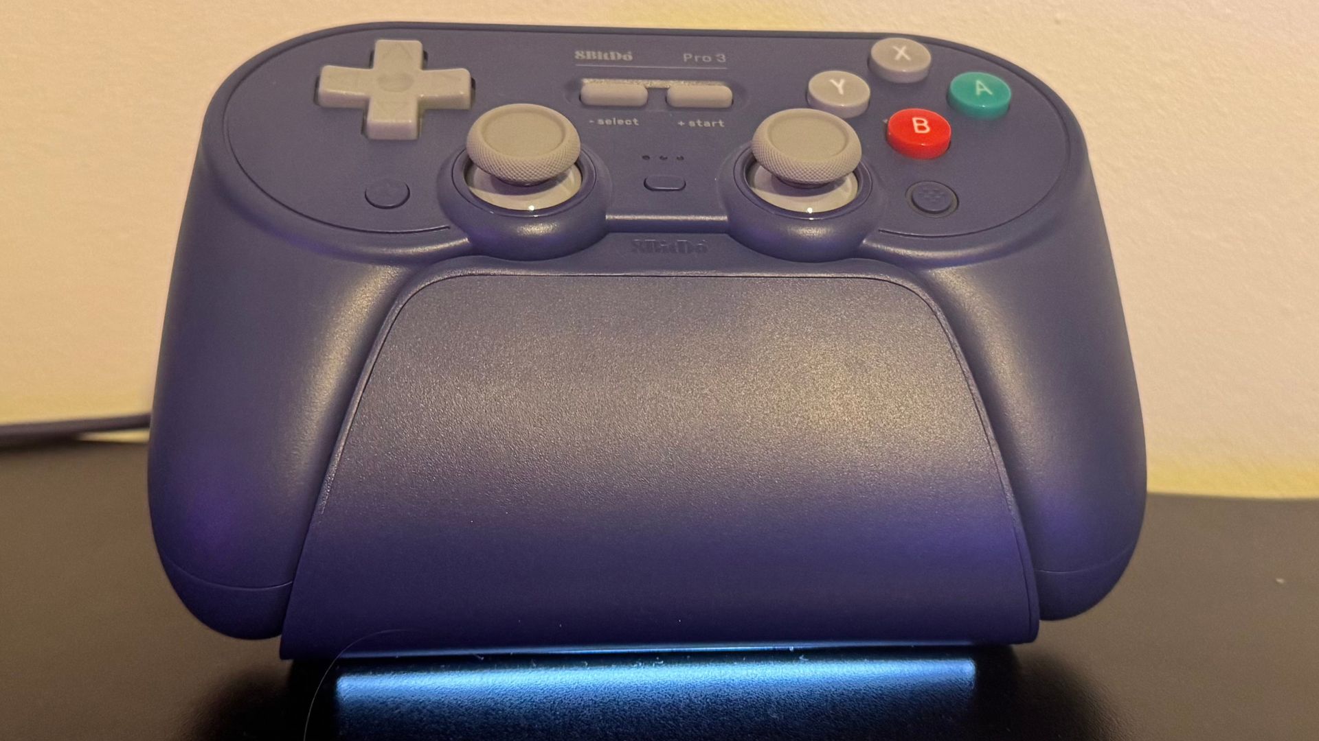 8BitDo Pro 3 gaming controller on charging dock